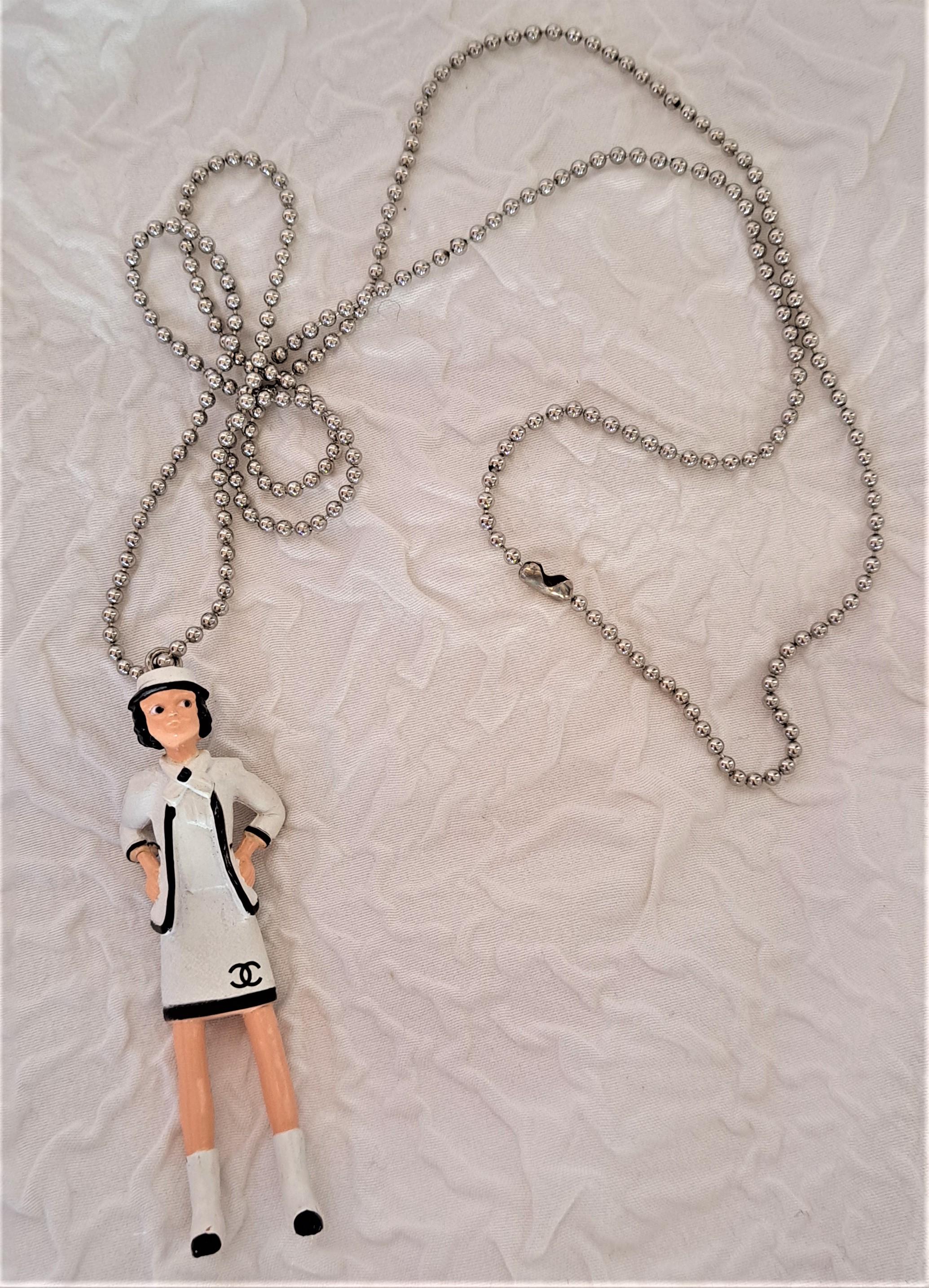 CHANEL Coco Mademoiselle Necklace LTD Edition Doll Extremely cute Limited Edition, circa 2003 CHANEL, COCO MADEMOISELLE figurine, doll bags key charm, necklace. Rare item.

This was a gift given out to only a few VIP clients at the CHANEL boutique