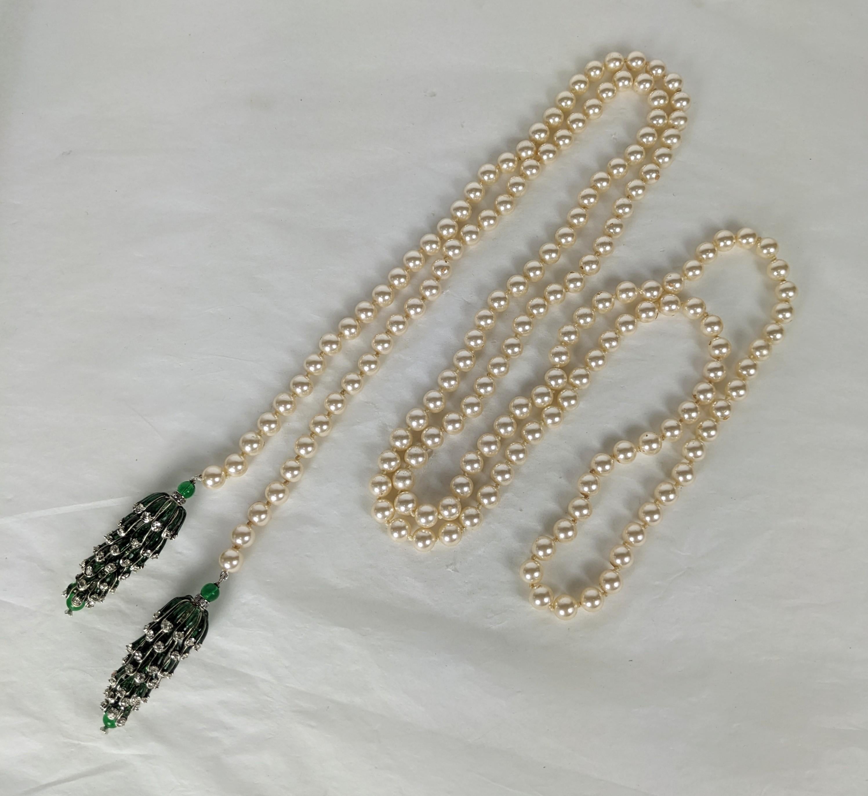 Rare Coco Chanel sautoir necklace 1950's by Maison Gripoix. The Art Deco inspired long necklace is composed of imitation glass hand knotted pearls with a pair of fine emerald poured glass enamel articulated pendants, decorated with minute prong set