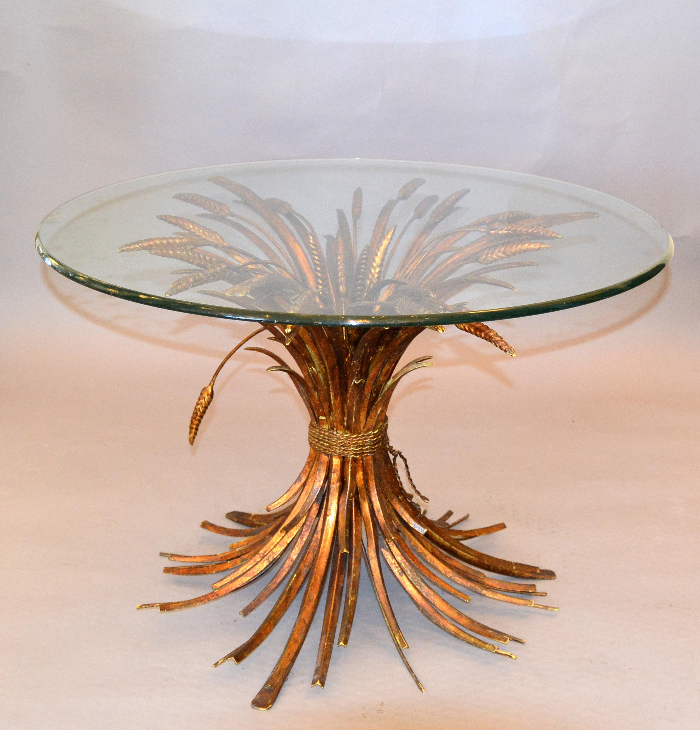 Hollywood Regency Coco Chanel style coffee table in gilt iron sheaf of wheat with glass top.
This table was made in Italy in the 1960s and shows a lot of patina.
The glass top has to be custom made prior shipping it is scratched.
 