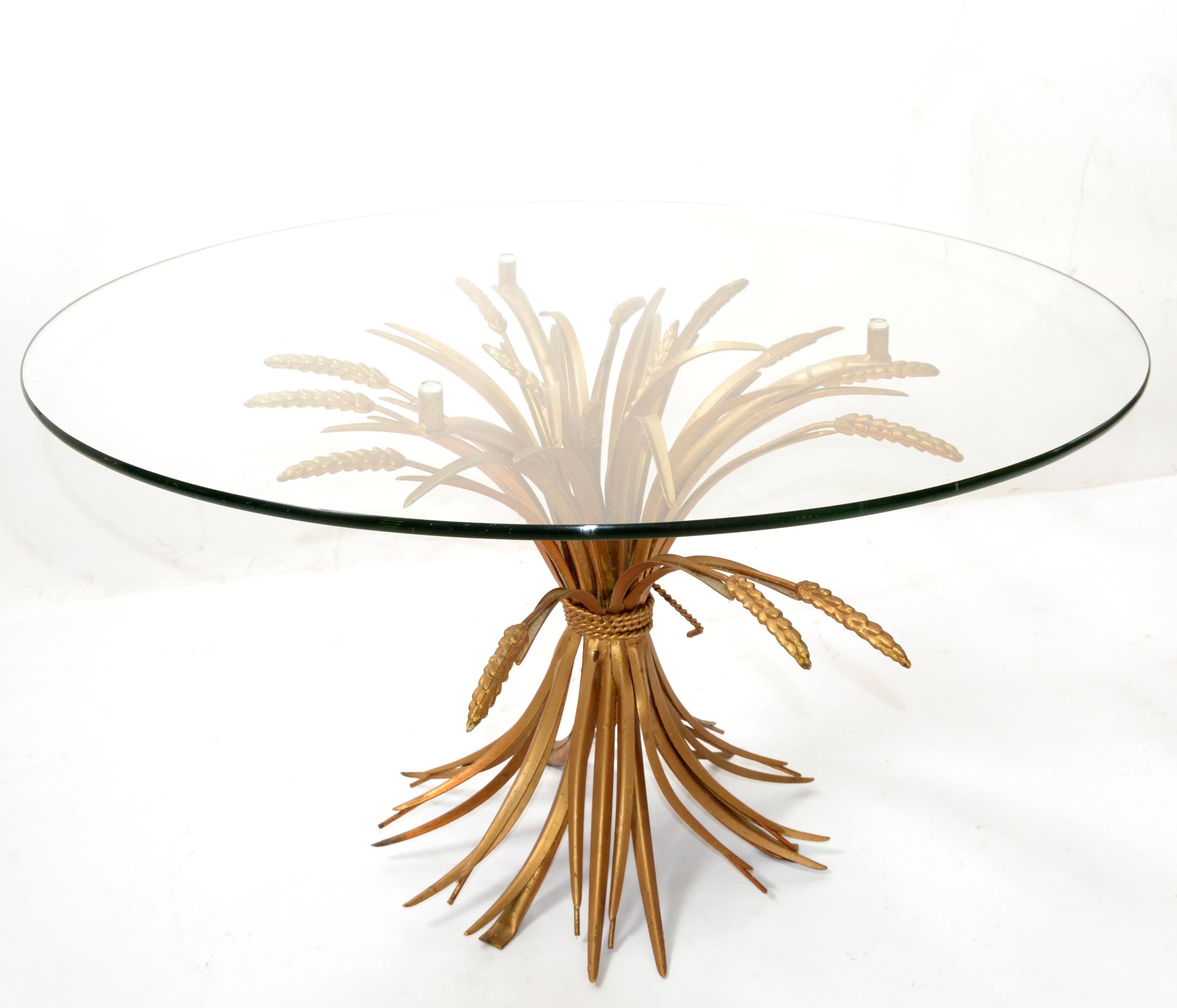 Hollywood Regency Coco Chanel style coffee table in gilt iron sheaf of wheat with glass top.
This table was made in Italy in the 1960s and shows a lot of patina.
The round glass top has been replaced. Base has age related wear. 