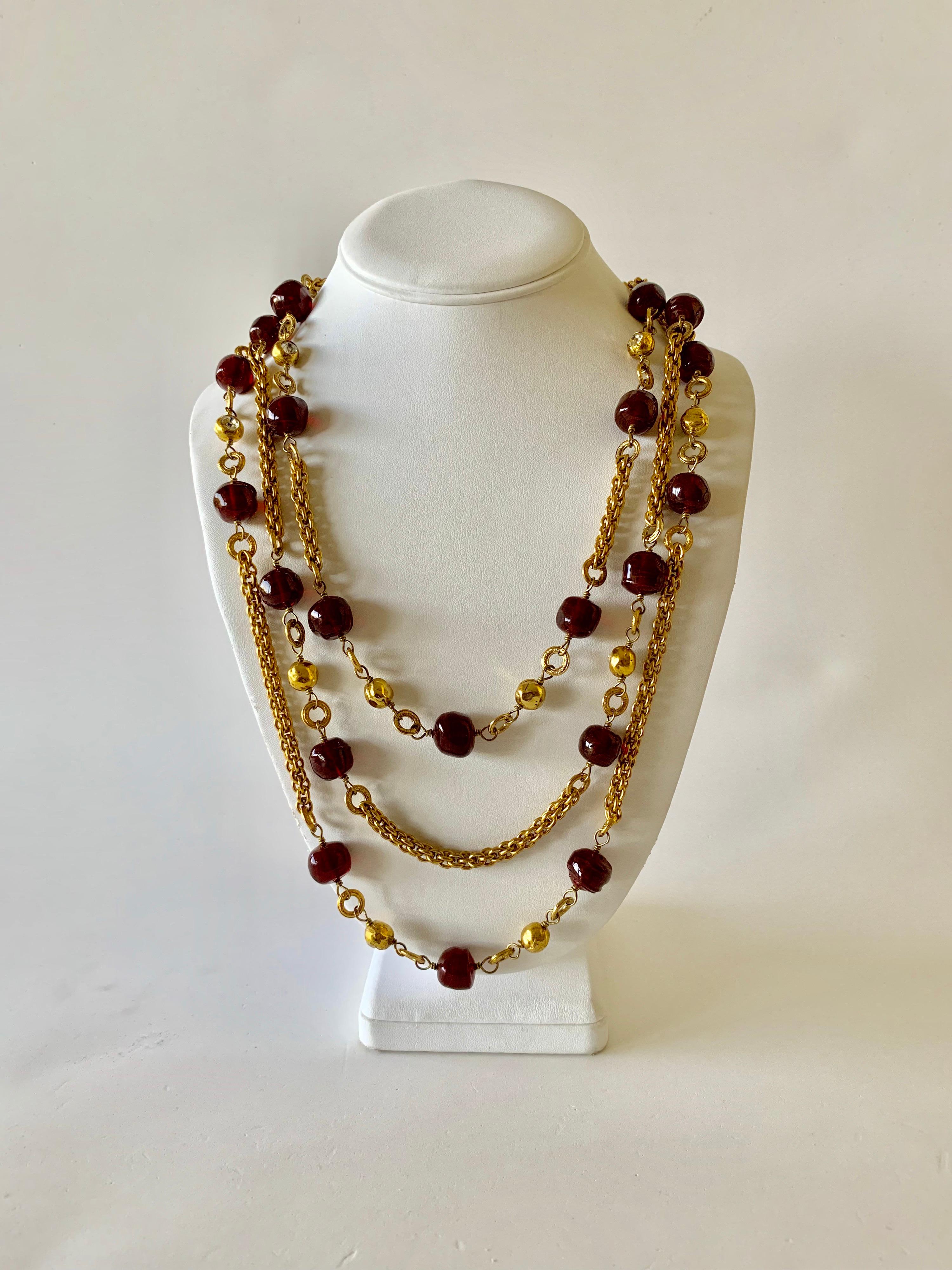 Beautiful vintage Coco Chanel triple strand cranberry statement necklace - by the famous Parisian Ateliers of Robert Goossens and Maison Gripoix. The necklace is comprised out of three strands of classic French rope chain with a combination of rich,