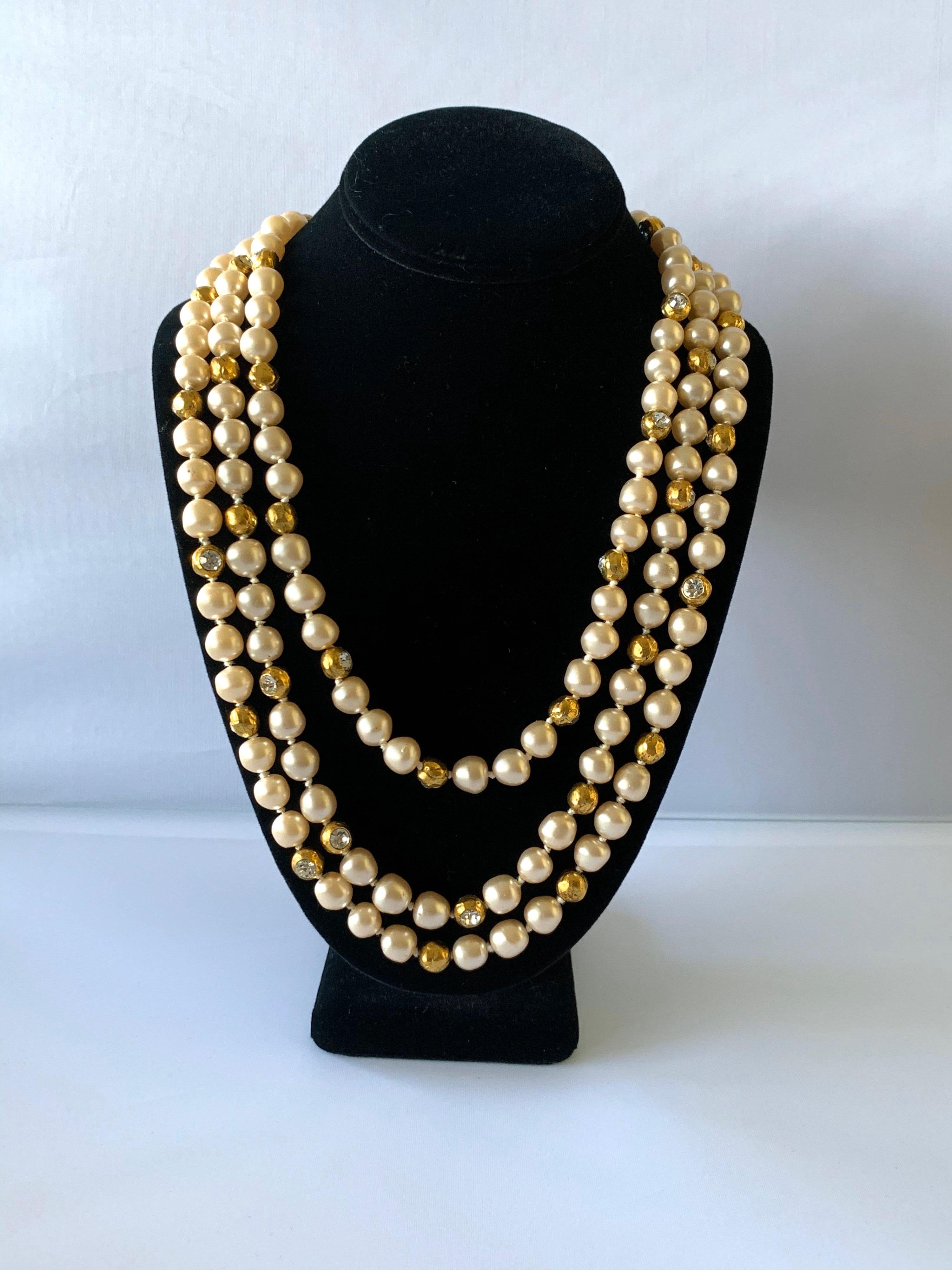 Vintage Coco Chanel triple strand pearl diamante statement necklace -  the necklace is comprised out of hand-strung cream colored faux pearls (executed by Gripoix) that are accented by gilt metal dore beads with large diamante rhinestones (executed