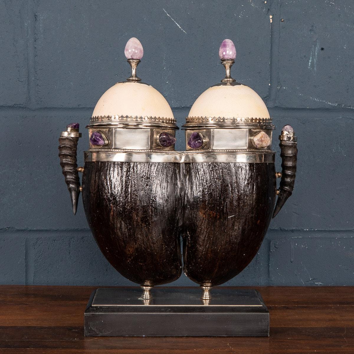 An extremely rare and unusual coco de mer box made in the 1970s by Anthony Redmile. Silvered mounts, ostrich egg lids, embellished with malachite, cabochons and finials, flanked by two African antelope horn handles, this item exemplifies Redmile’s