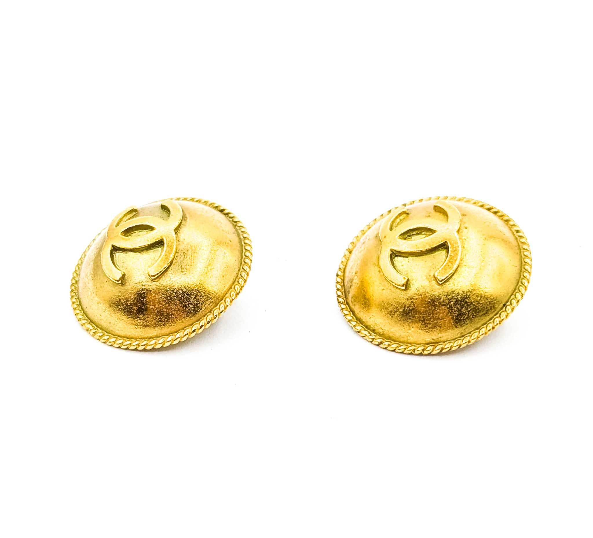 Discover Timeless Elegance with Chanel

Step into a world of classic sophistication with these Vintage Coco Chanel Round CC Button Earrings. Crafted in 1994, these exquisite gold-plated brass earrings capture the essence of Chanel's iconic style.