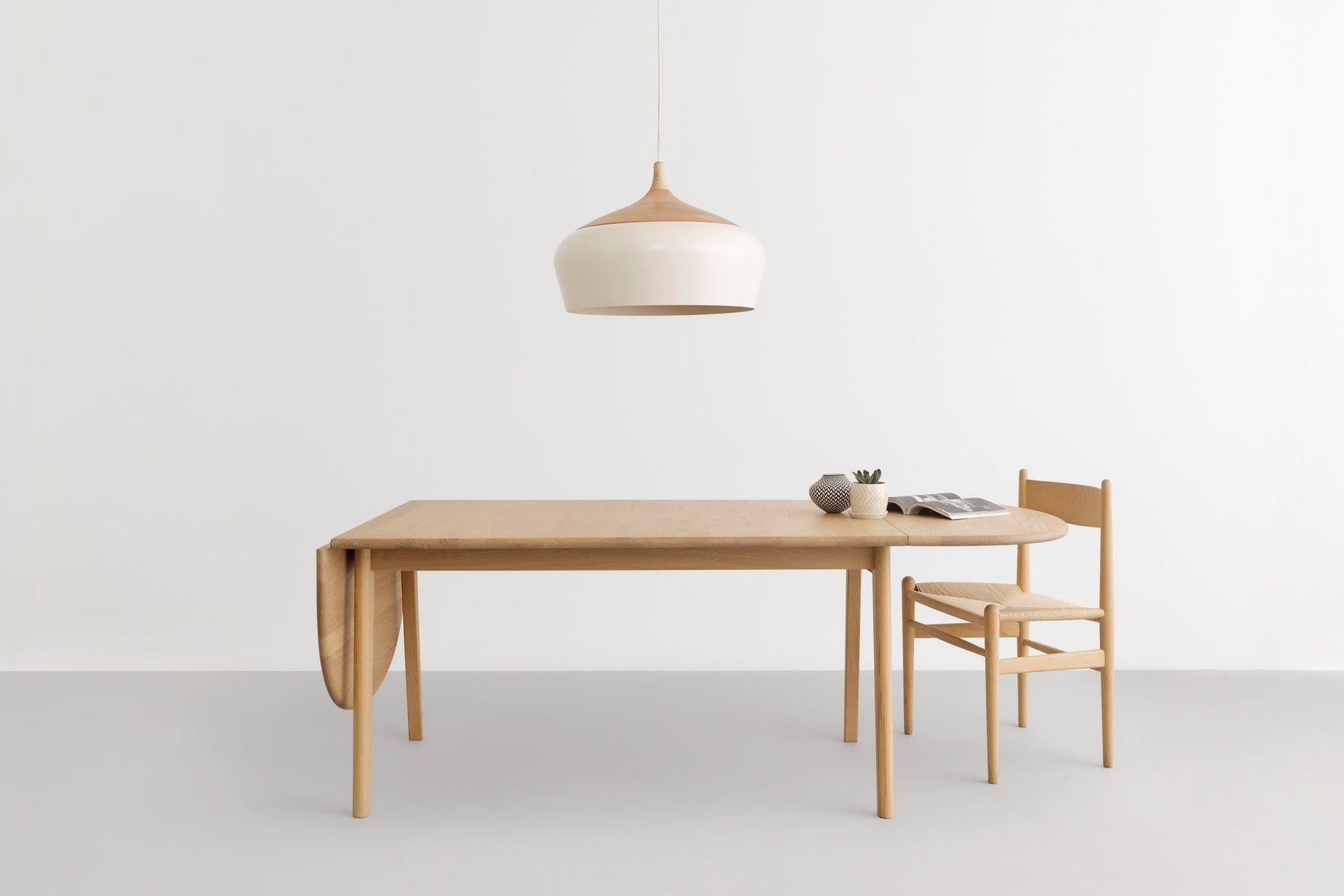 Influenced by Scandinavian and Japanese aesthetics, Coco's hand-turned victorian ash top holds its spun white, powdercoat aluminum shade. Like a beautiful, heavy yo-yo at the end of its string, Coco hangs in space with a silent poise. Do as the