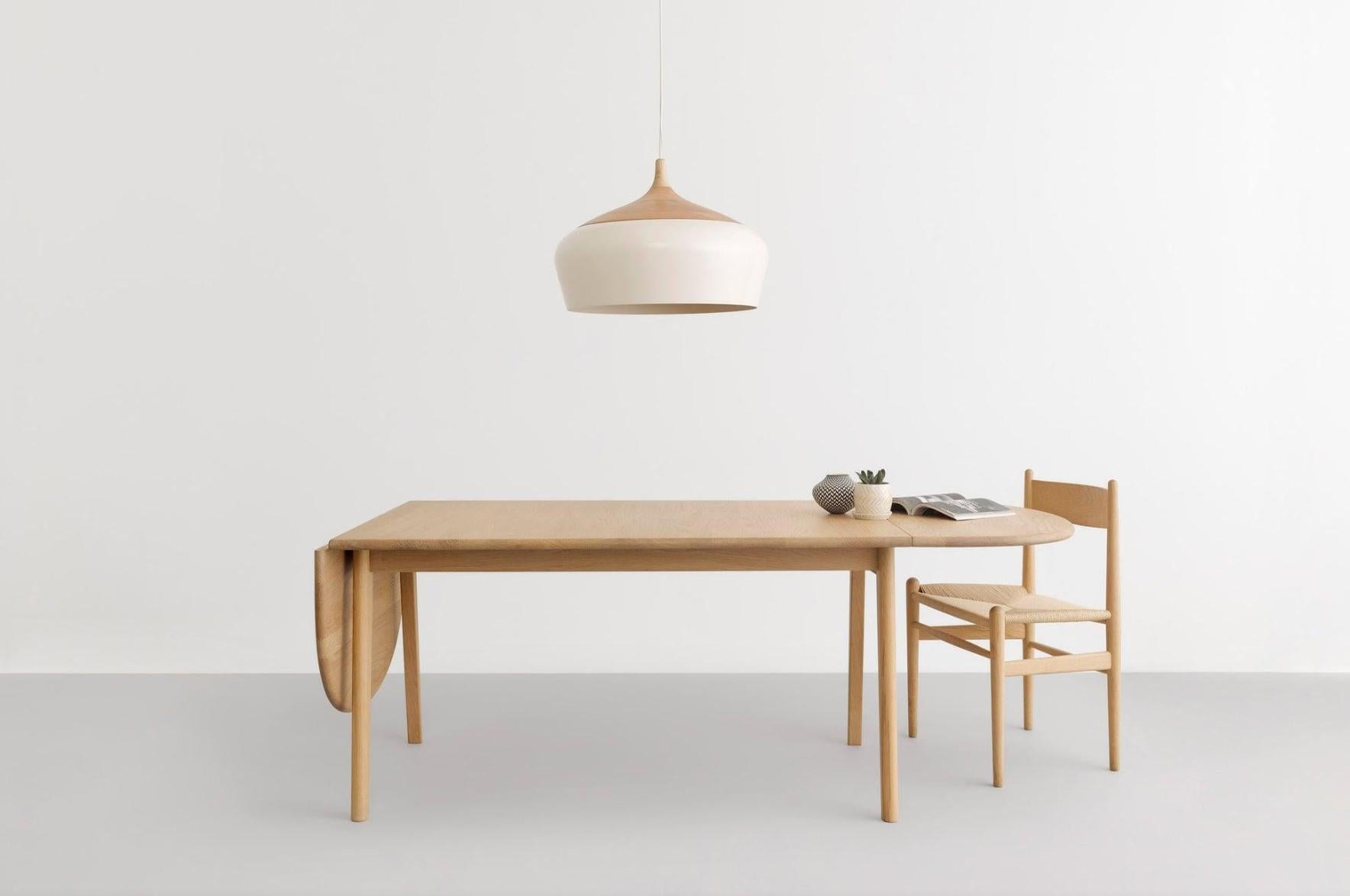 Influenced by Scandinavian and Japanese aesthetics, Coco's hand-turned victorian ash top holds its spun white, powder coat aluminum shade. Like a beautiful, heavy yo-yo at the end of its string, Coco hangs in space with a silent poise. Do as the