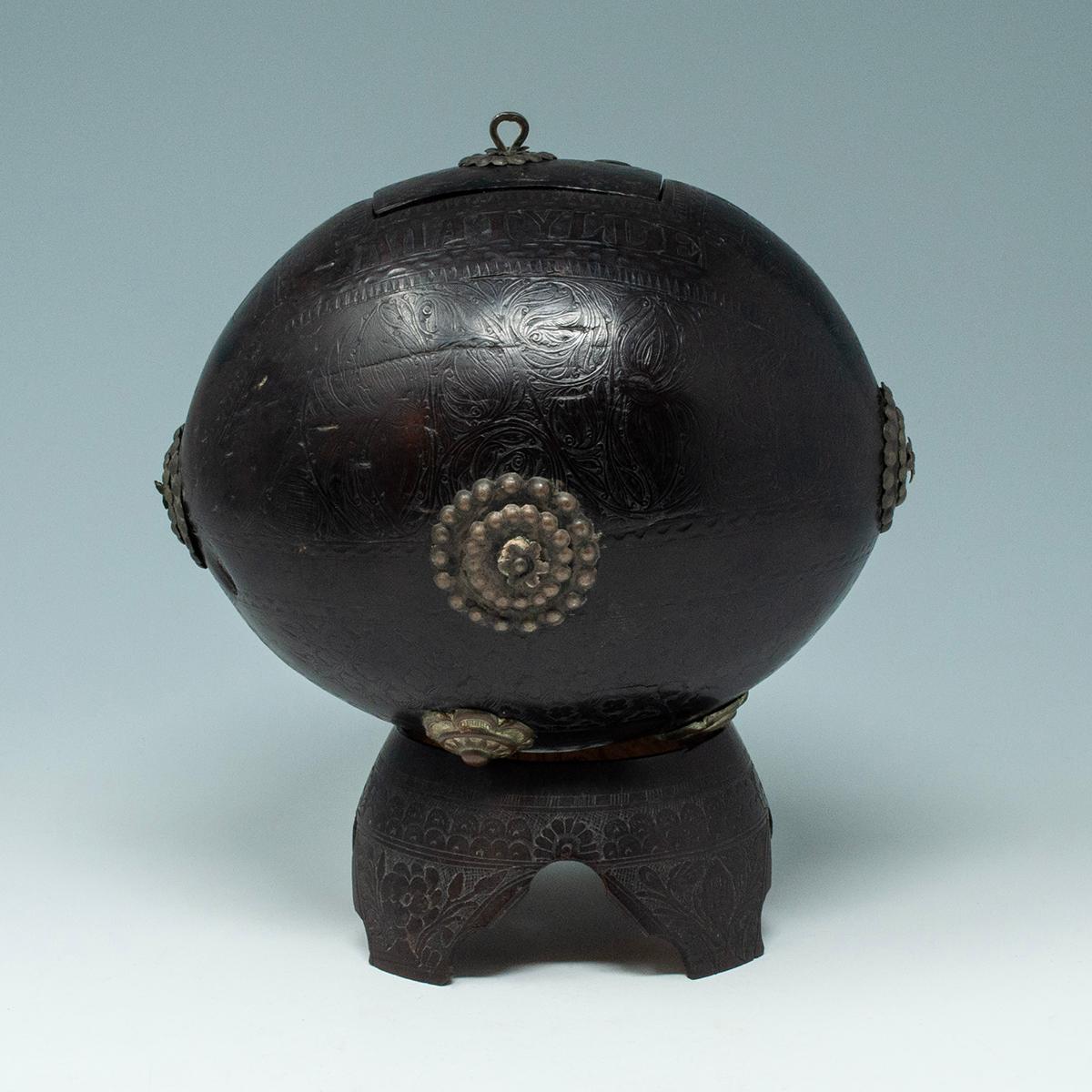 Coconut Bugbear Box/Tea Caddy by Unknown Sailor

A large carved coconut bugbear in the form of a box with a metal hinged lid. Carved around the lid are the words SOI D. MATYLDE BRENES, which is a Spanish name found in Mexico and Costa Rica. The