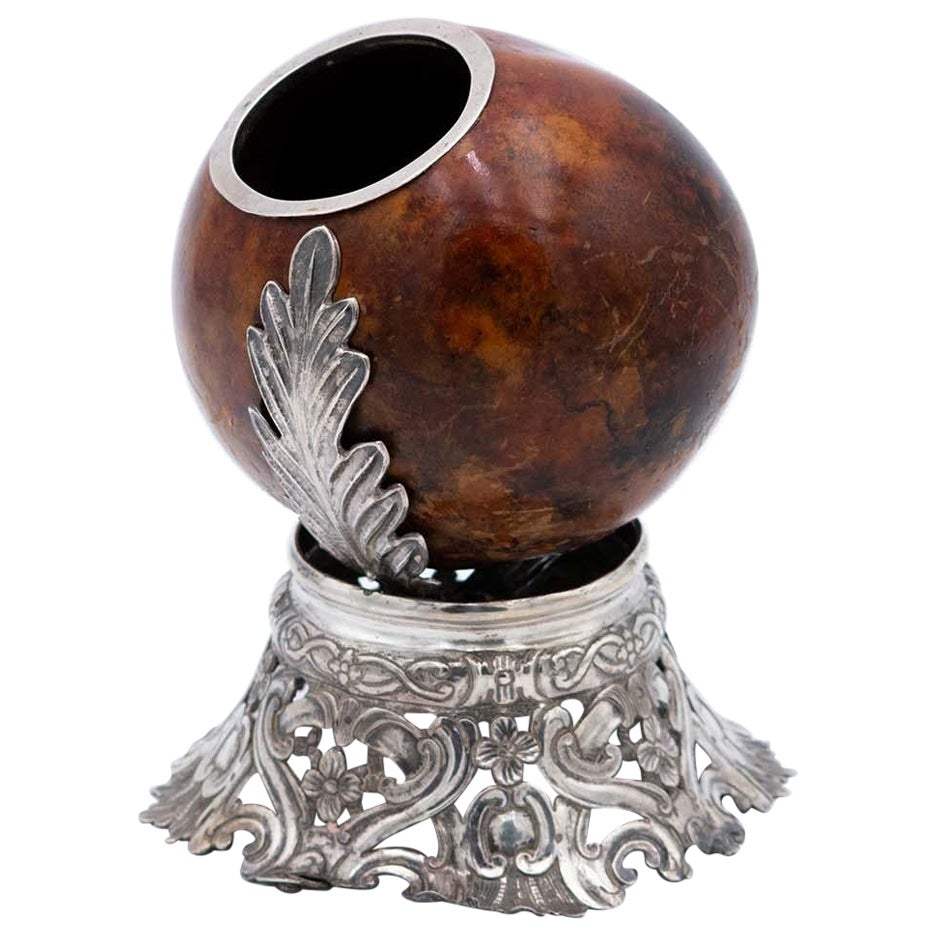 Coconut-shaped mate gourd with a South American cut-out silver stand