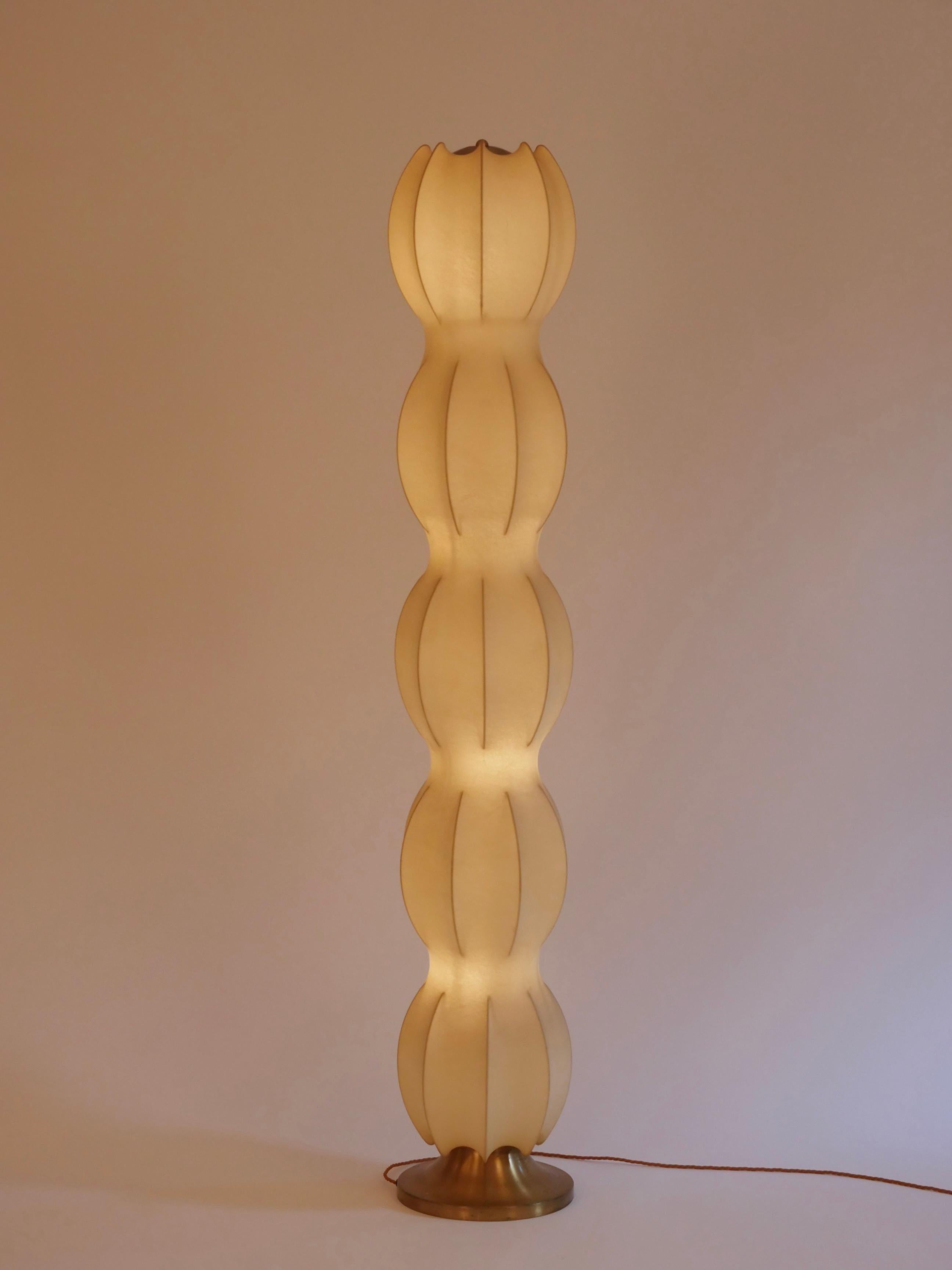 Mid century cocoon floor lamp with lovely warm patina to resin shade.

Small tear 1cm.