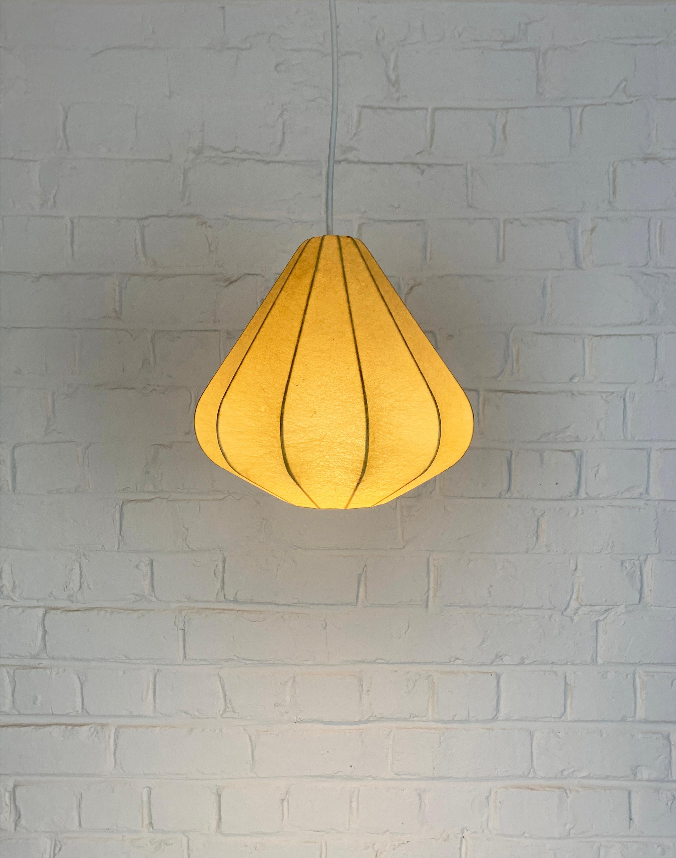Cocoon pendant lamp. Design by Friedel Wauer. Manufactured by Goldkant Leuchten, Germany in the 1960s.

A thin steel framework covered with sprayed resin, which gives a Fiberglass look. The translucent resin gives a beautiful soft light effect. 

A