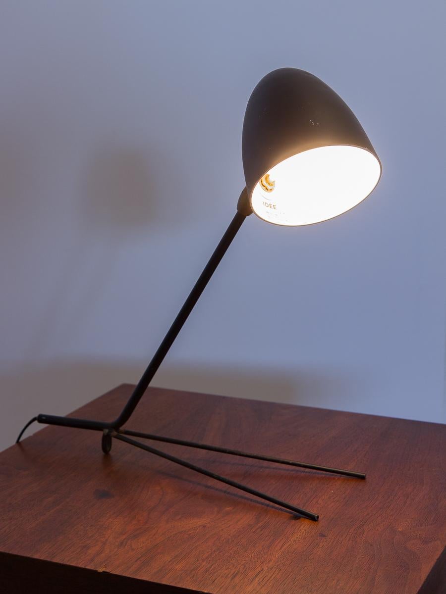 The cocotte desk Lamp was created by French lighting design pioneer Serge Mouille in 1957. Our lamp is an early reissue from the 1980s, made in Japan for Idee. Lamp has lovely patina and wear that appears more aged. Lamp can also be hung from a