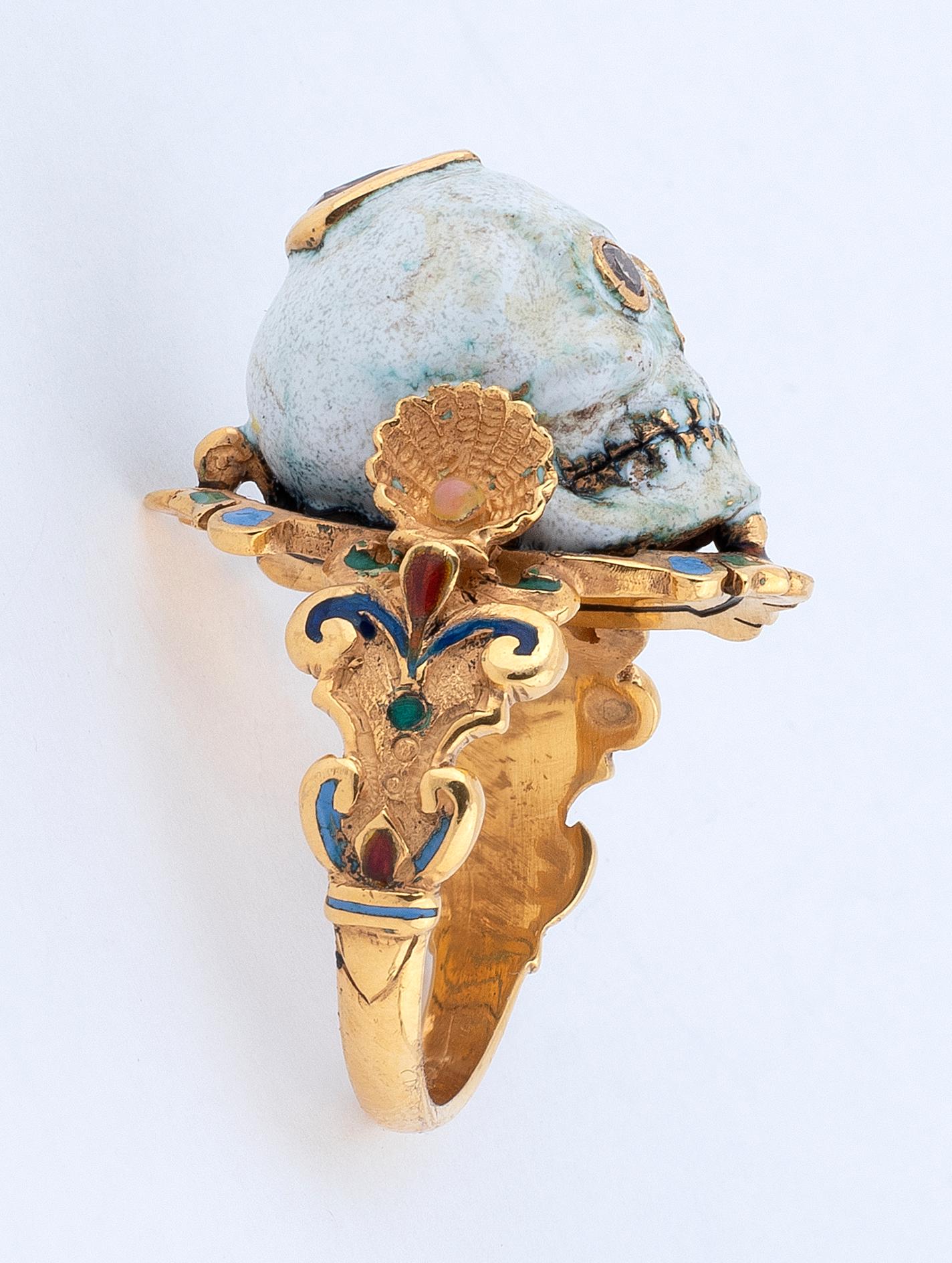 The Renaissance style Memento Mori skull with champleve multicolored enamels, round cut diamonds eyes and pear cut diamond at the top.
Mounted in 18Kt yellow gold
Signed A. Codognato Venezia
Weight: 15.8 gr
Finger size: 9 1/2