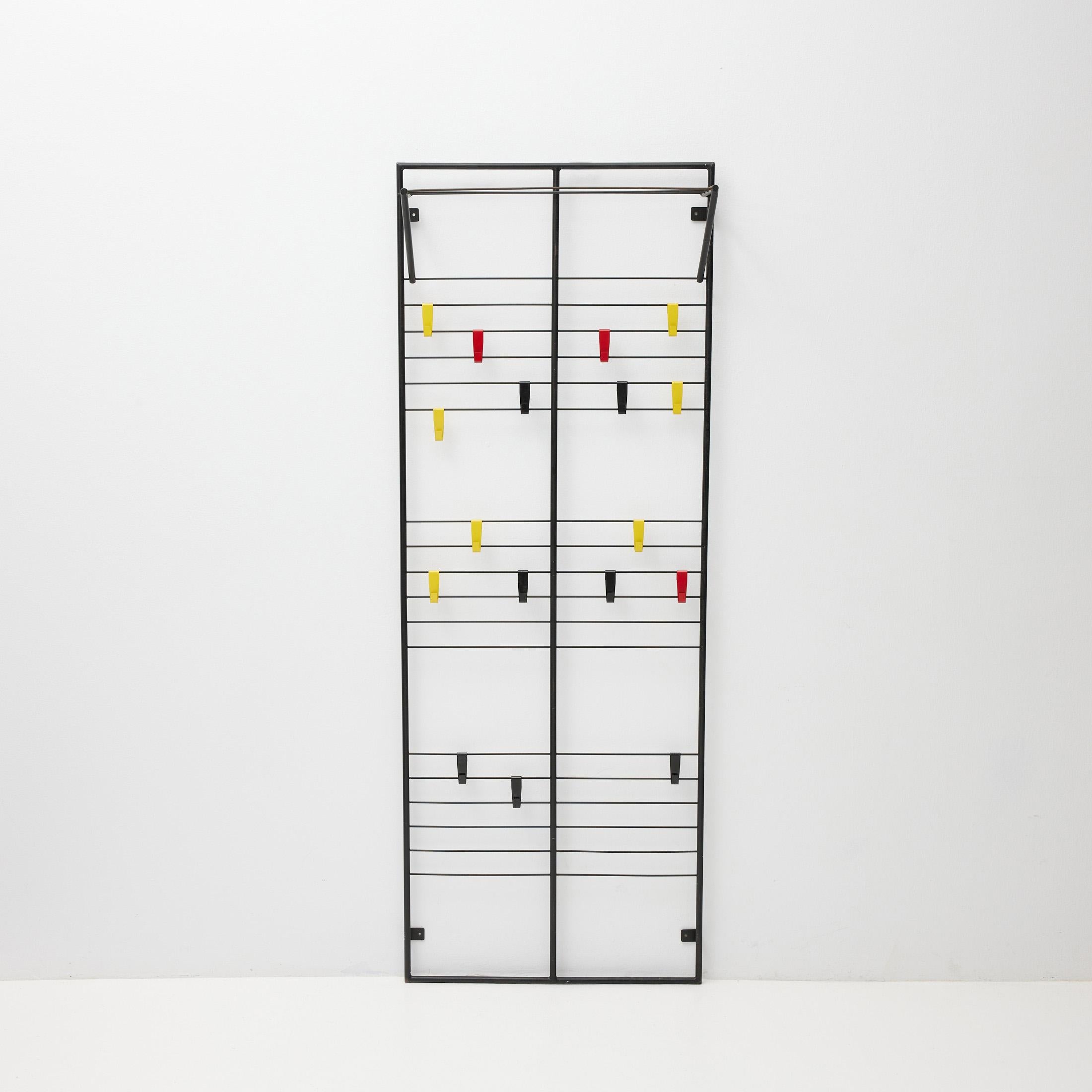 Coat rack designed by Coen de Vries, circa 1950.
Manufactured by Devo, Netherlands

Lacquered steel frame.

In good original condition, with minor wear consistent with age and use, preserving a nice patina.