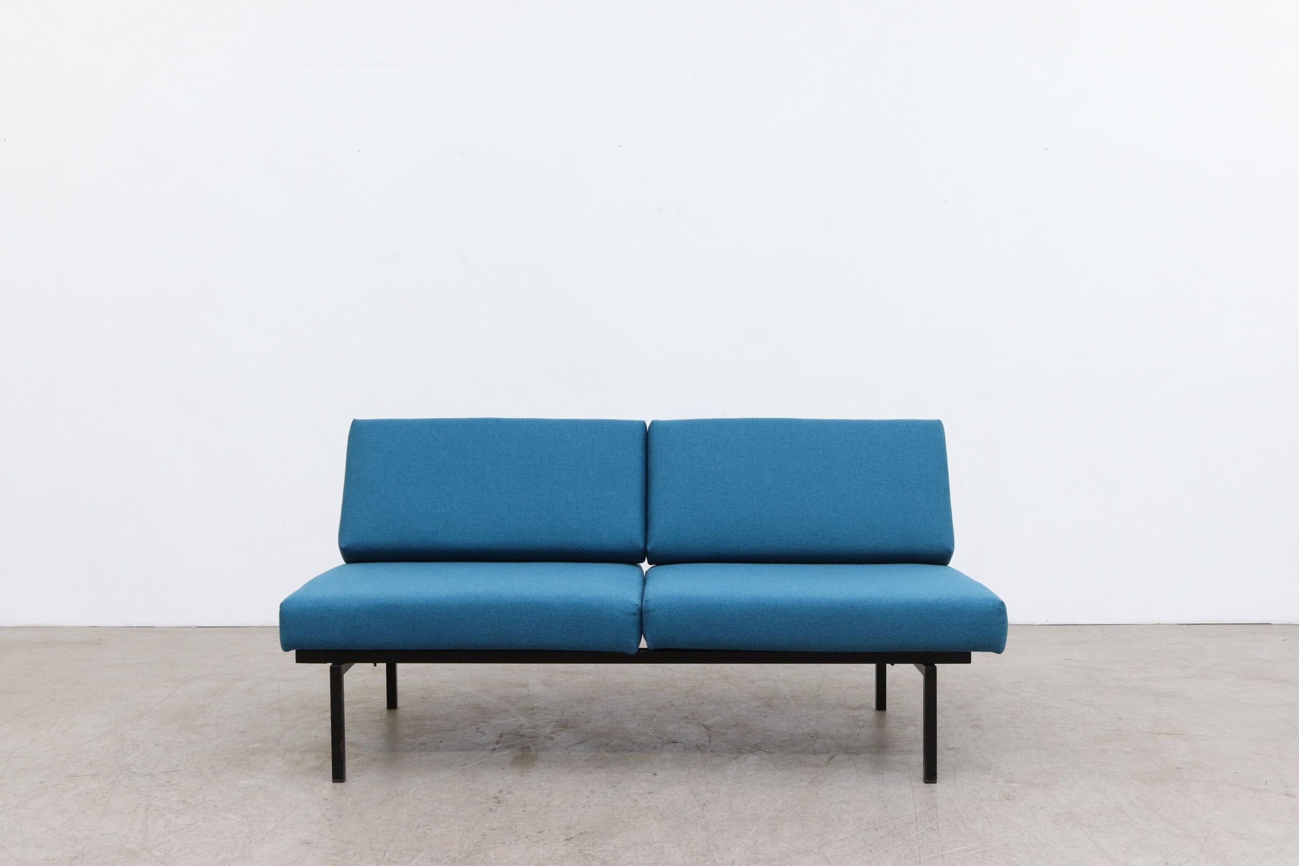 Coen de Vries for Pilastro Convertible sleeper loveseat with new azure blue cushions. The back frame flips over and the bottom frame holds Interior bars that extend out from under loveseat to make bed. The frame is in original condition with visible