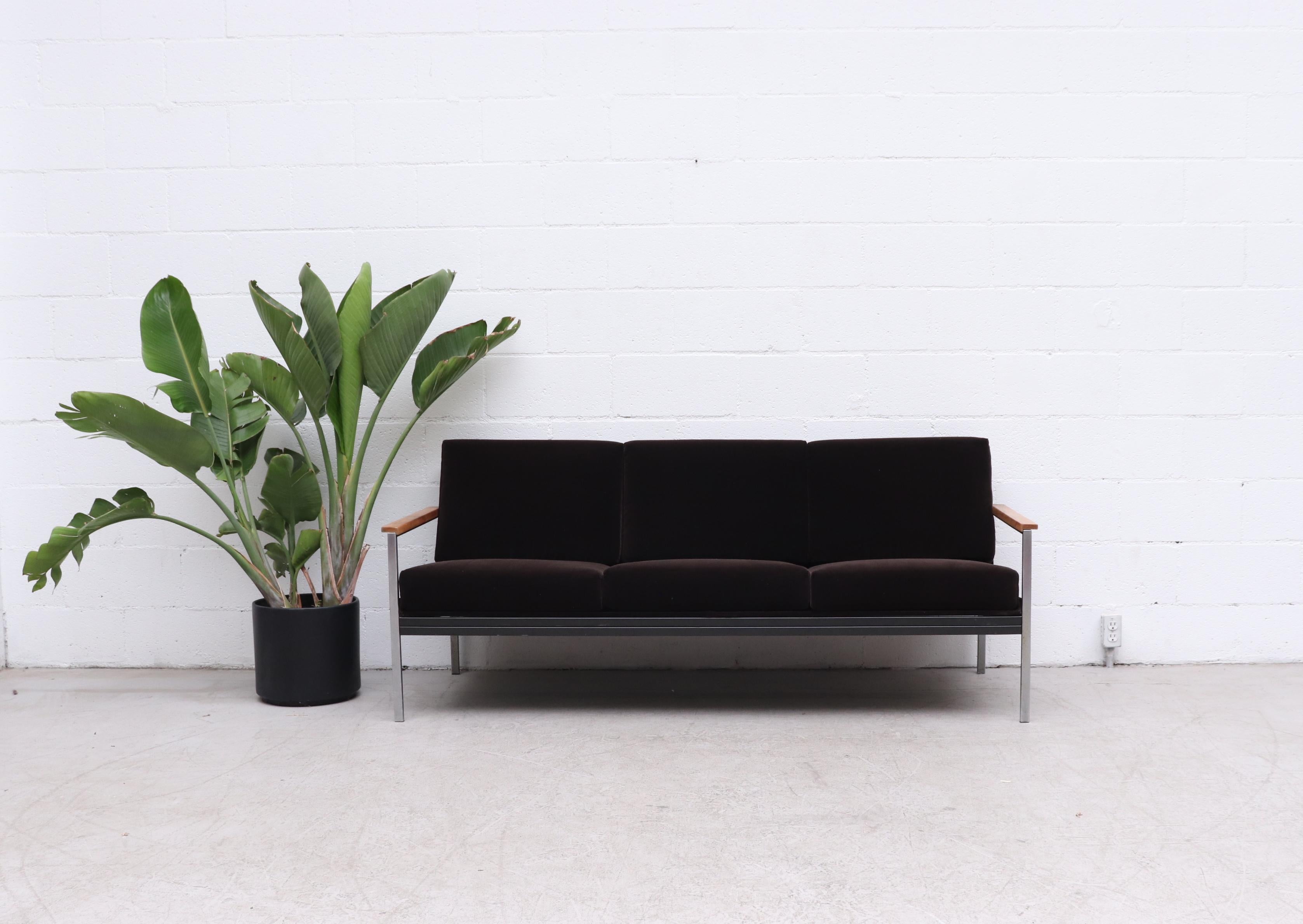 Beautiful, mid-century, 3-seat sofa with mocha velvet upholstery, steel frame and lightly refinished natural wood armrests. Designed by Coen de Vries. As a leading member of the Goed Wonen foundation, De Vries was of great significance for the