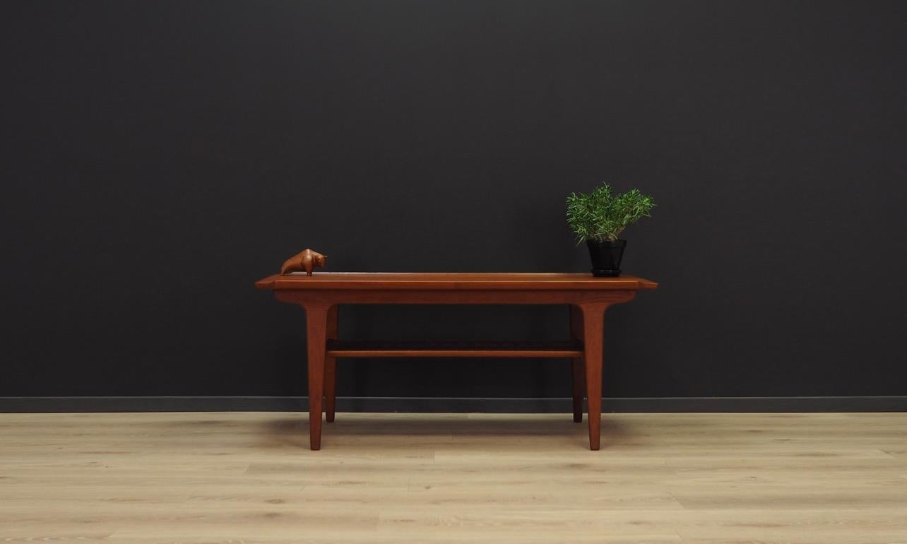 Classic coffee table from the 1960s-1970s, Minimalist form, Danish design. The whole is covered with teak veneer. Under the counter there is a shelf made of silicone net. Preserved in good condition (small bruises and scratches) - directly for