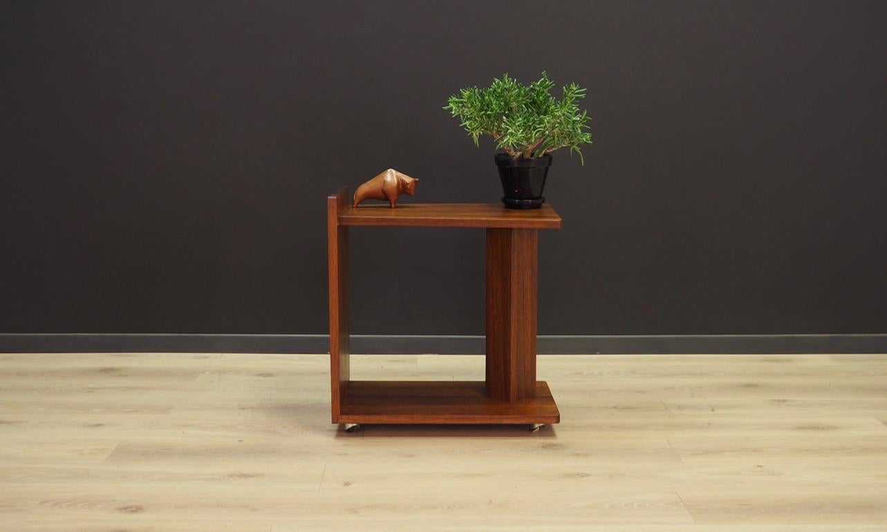 Minimalistic coffee table of the 1960s-1970s, Scandinavian design. Covered with mahogany veneer on wheels. Preserved in good condition (minor scratches).

Dimensions: Height 58 cm, width 54 cm, depth 34.5 cm.