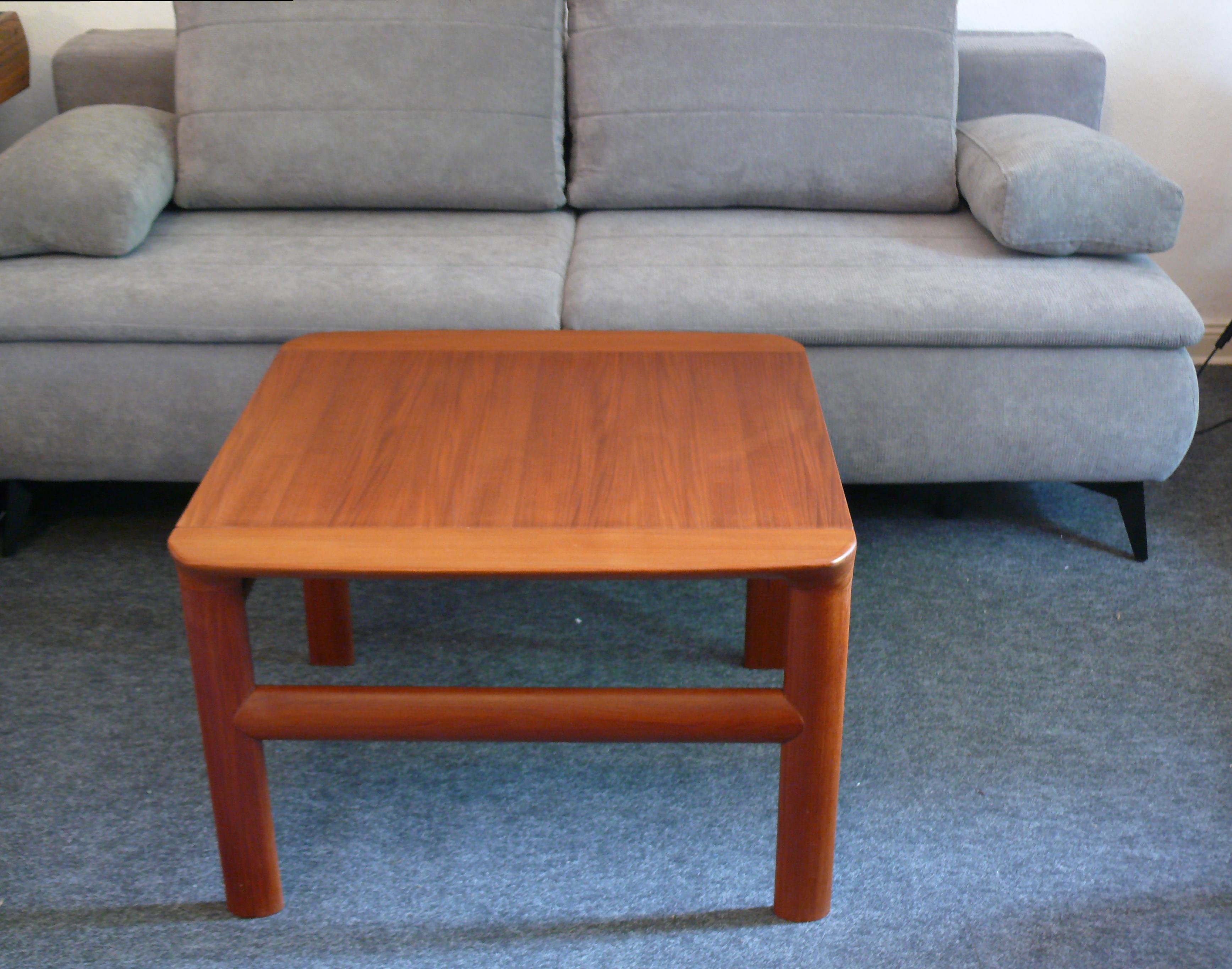 Well-preserved coffee table/side table by Juul Kristensen for the company Komfort - Denmark, from the 1960s. Made of solid teak, it is very sturdy. The tabletop is screwed between the side frames, which are artfully sanded at the top, giving the