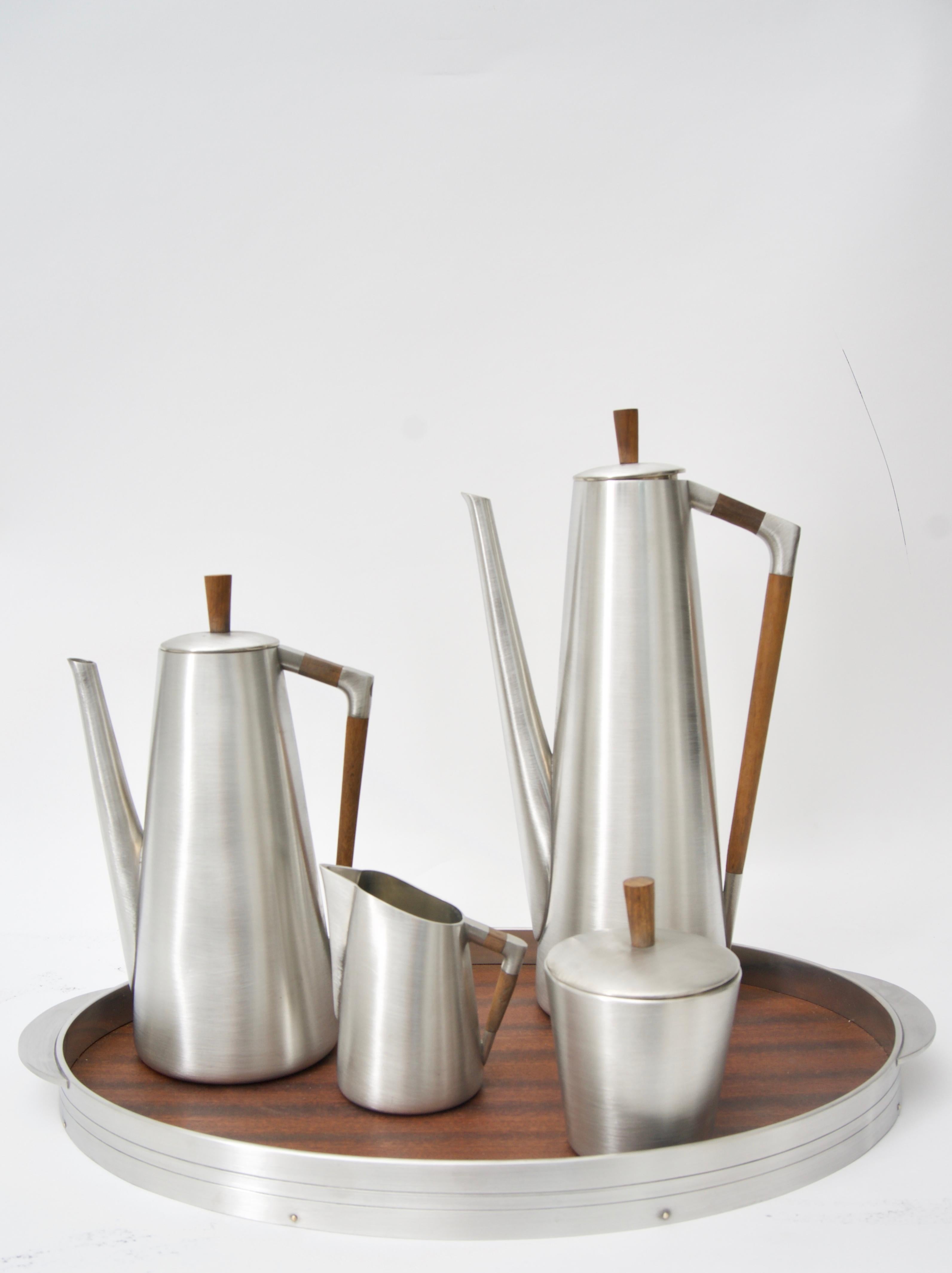 This stylish pewter coffee and tea service is by the KMD Royal Holland and will make a definite statement with its clean lines, form and use of materials. 

Note: Dimensions of the coffee pot are 12.25