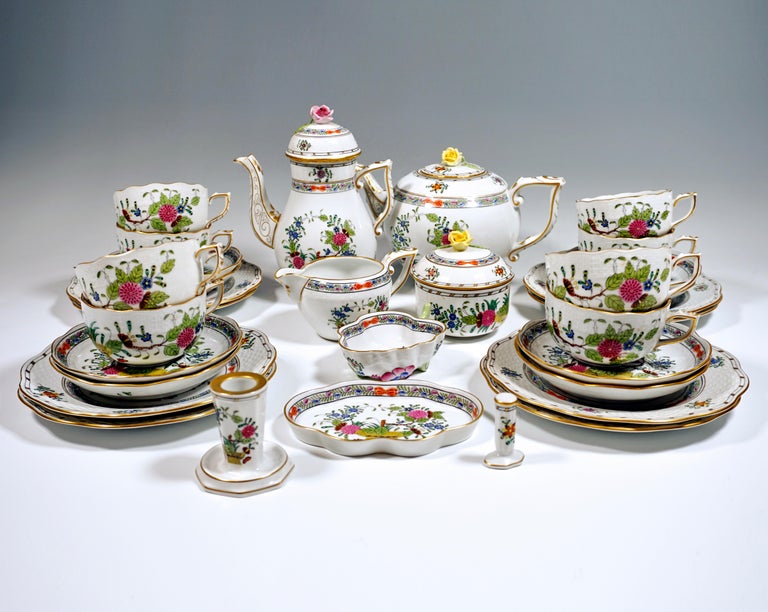 Herend service consisting of 32 parts: coffee pot with lid, teapot with lid, milk jug, sugar bowl, eight cups, eight saucers, eight dessert plates, a candle holder, a candy bowl, an ashtray and a cigarette steamer.
Shape: Osier / basket