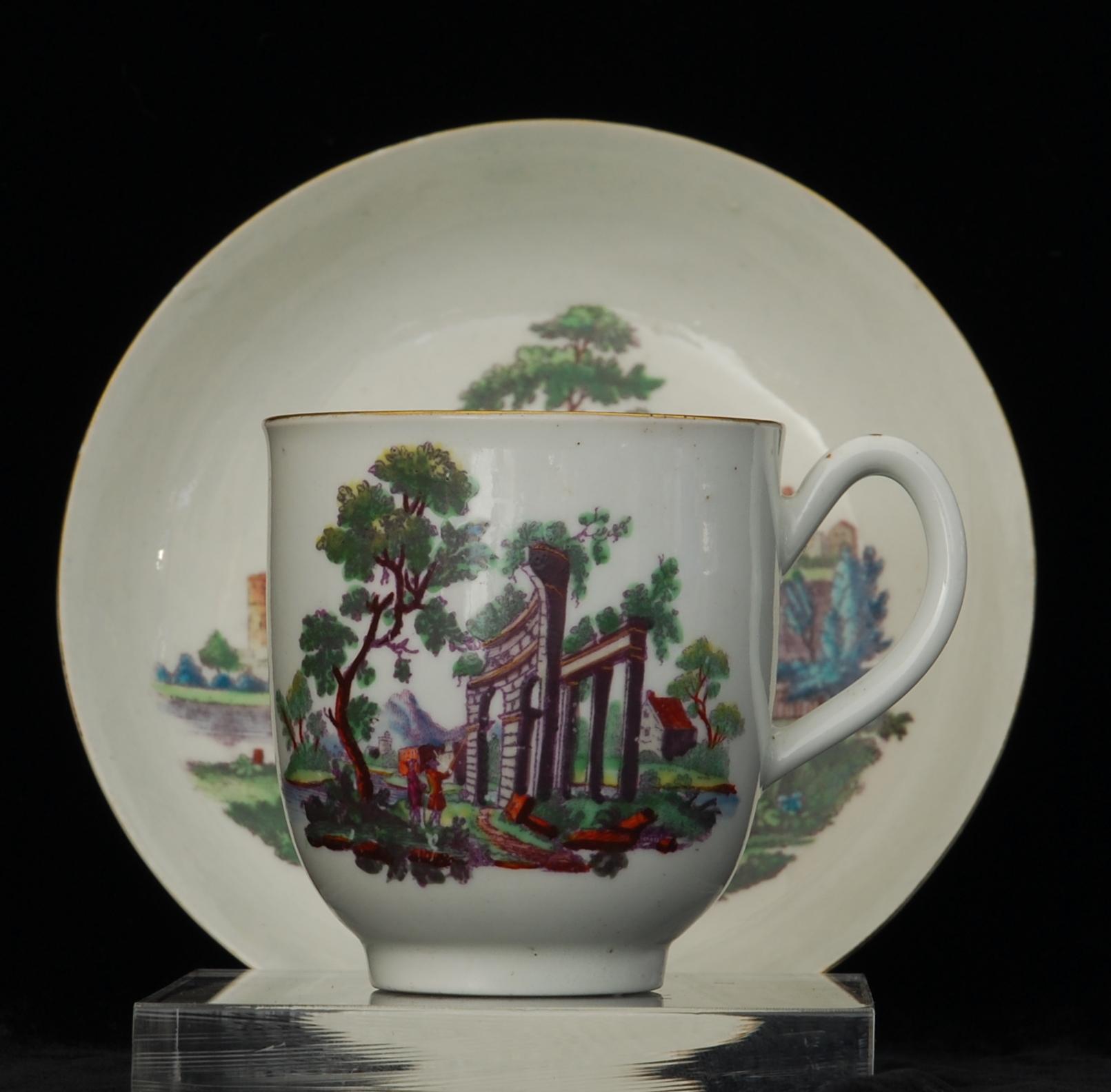 Coffee cup and saucer, decorated with a Hancock type print in black overglaze, which has then been coloured with enamels and highlighted with gilt. 

The decoration possibly James Giles Workshop; the palette is his and the style matches a signed