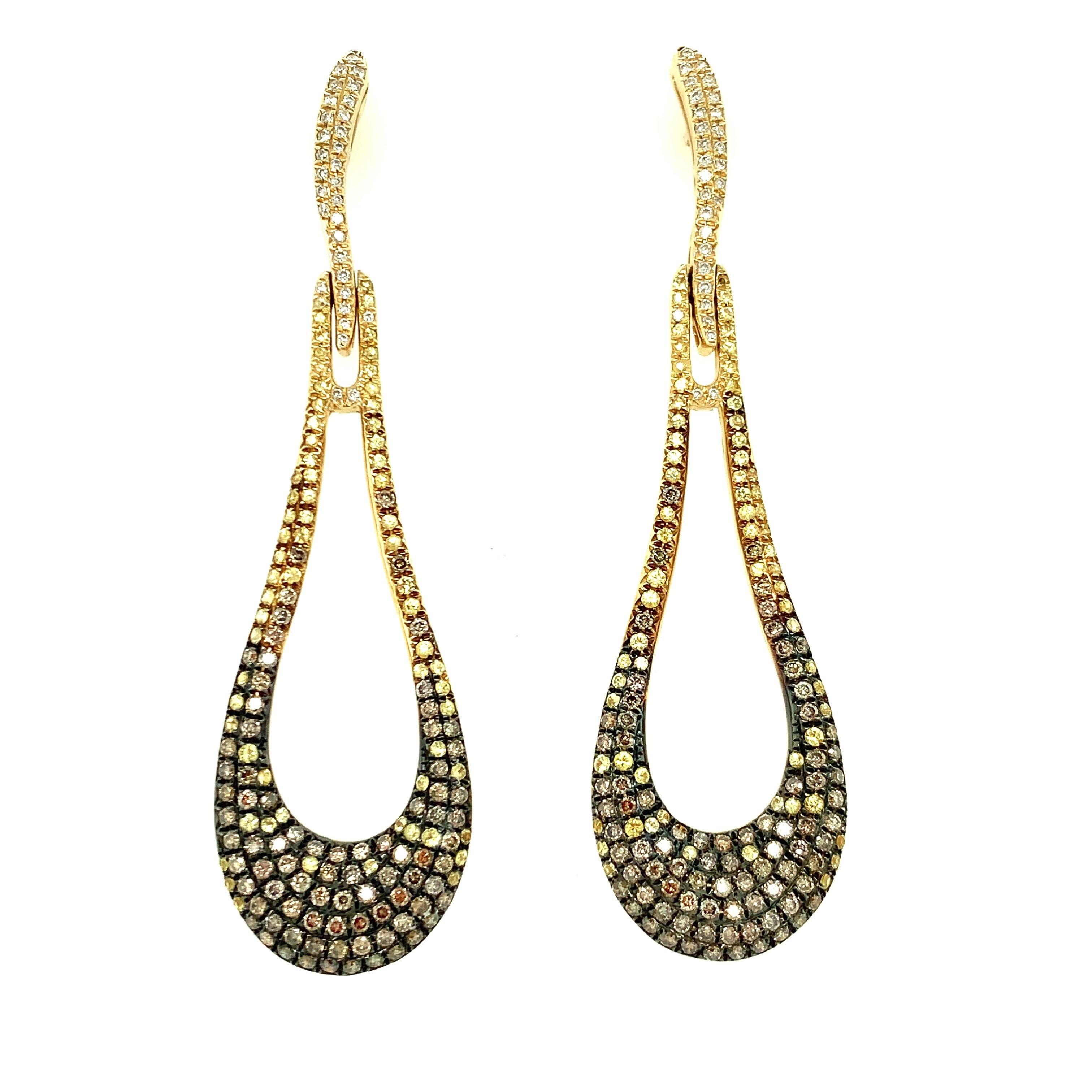 The ombre effect of these diamond, sapphire, and gold earrings make them stunning with a truly unique twist. Sparkling diamonds ranging in color from light champagne to warmer coffee tones are blended with yellow sapphires to give these earrings a