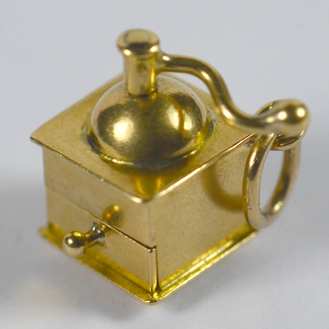 The perfect gift for the coffee lover in your life! This charming French pendant is designed as a coffee grinder with rotating handle and a drawer which opens up to reveal a ruby love heart.  An unusual charm with French marks for 18 karat gold.