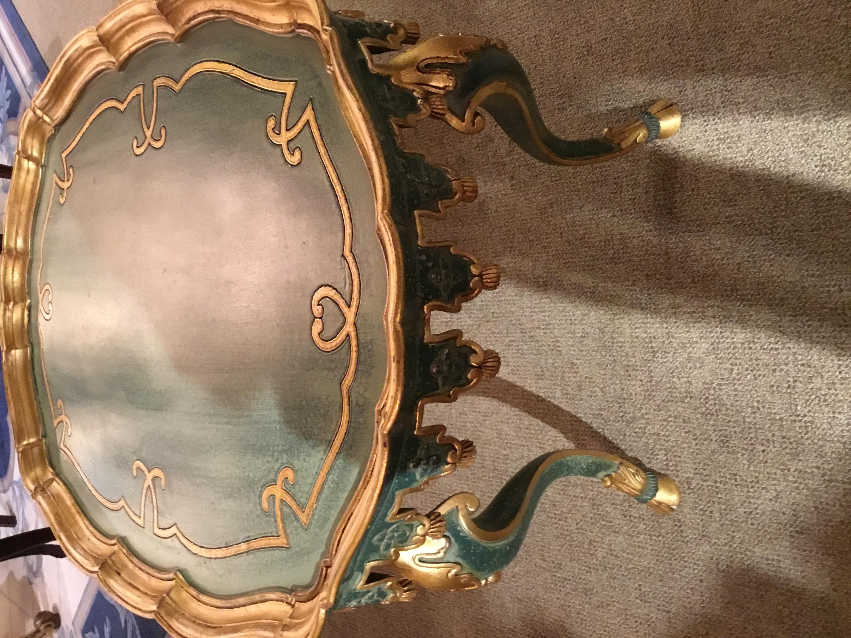 Beautifully shaped table in a graceful oval. Faux painted in shades of sea green with
Gold gilt edges. Carved and shaped tassel edge is also highlighted in gilt gold.