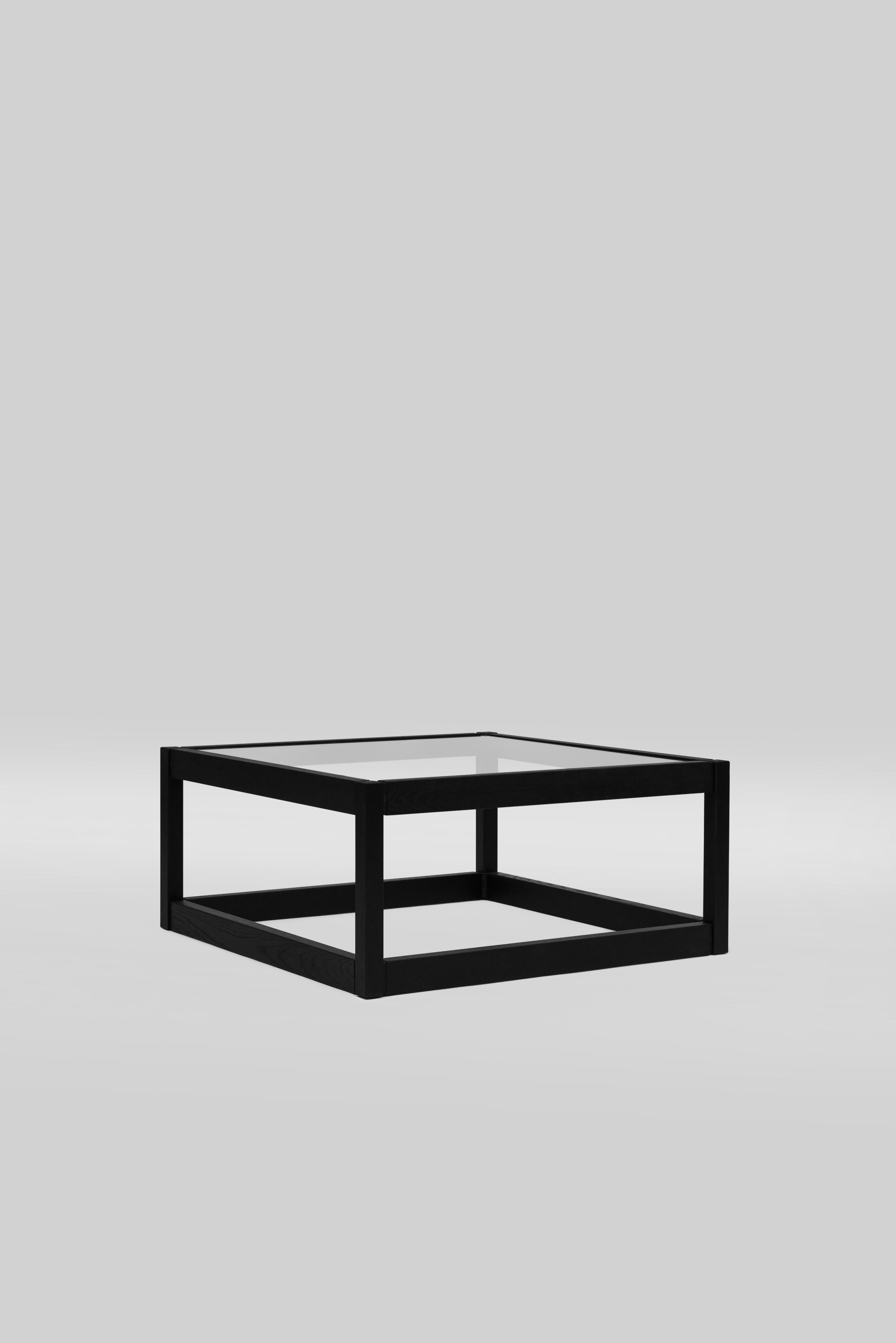 The T83/2 is the bigger version of the T83 series. The T83/2 is shaped like a cube. The lower level is at the floor, without glass. The table frame is made of solid wood and small casted parts connecting the wood. The glass has a thickness of 10 mm