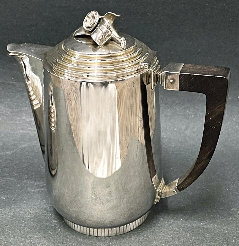 Exquisitely designed and executed, this Art Deco coffee pot and sugar bowl form an elegant pairing, and were made by Erik Fleming's Atelier Borgila in Sweden in 1953. Each piece is surmounted by a hinged lid with repeated setbacks, topped by a