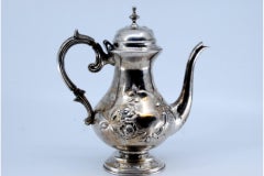 Coffee pot in embossed silver w/ floral motifs & engraved base & knob on the lid