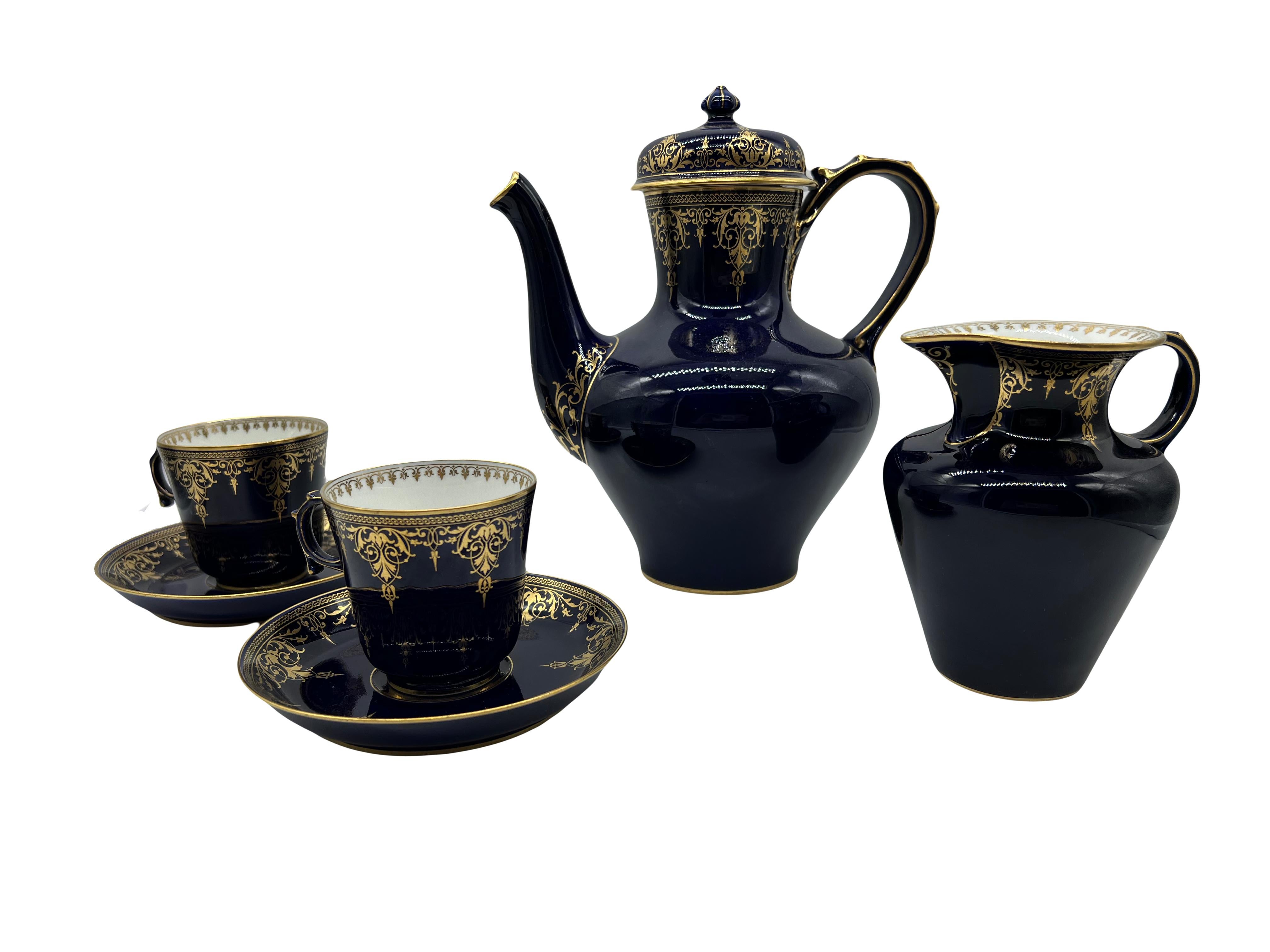 Set comprising a covered coffee pot, a milk jug, and two cups and their saucers
Porcelain cup and saucer decorated with golden lambrequins on a midnight blue background.
Signed and dated 1870 and 1889

Sèvres stamp:
Cups: S70 / S74, gilded 76.