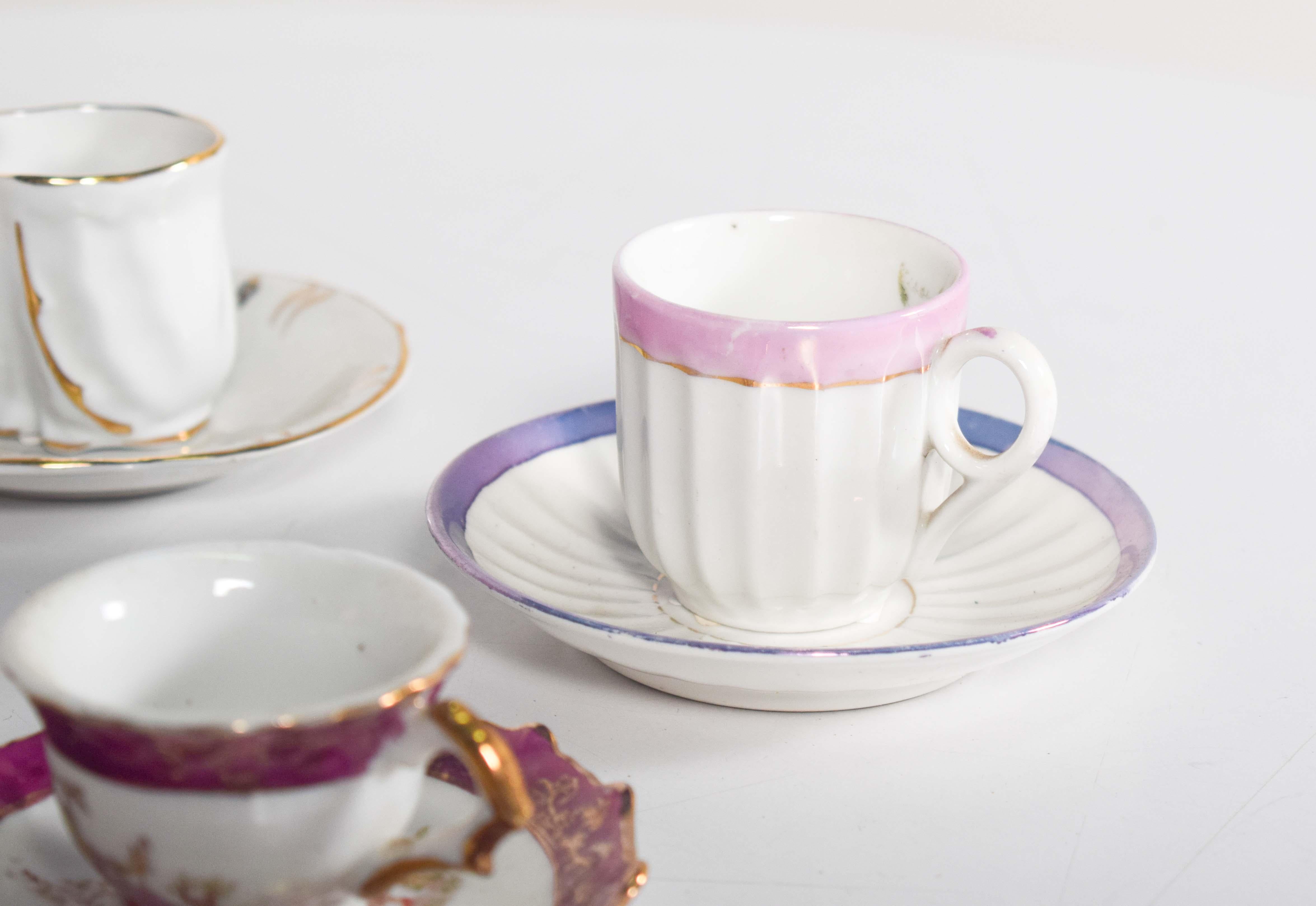 Porcelain Coffee Set of Four Different Cups and Saucers For Sale
