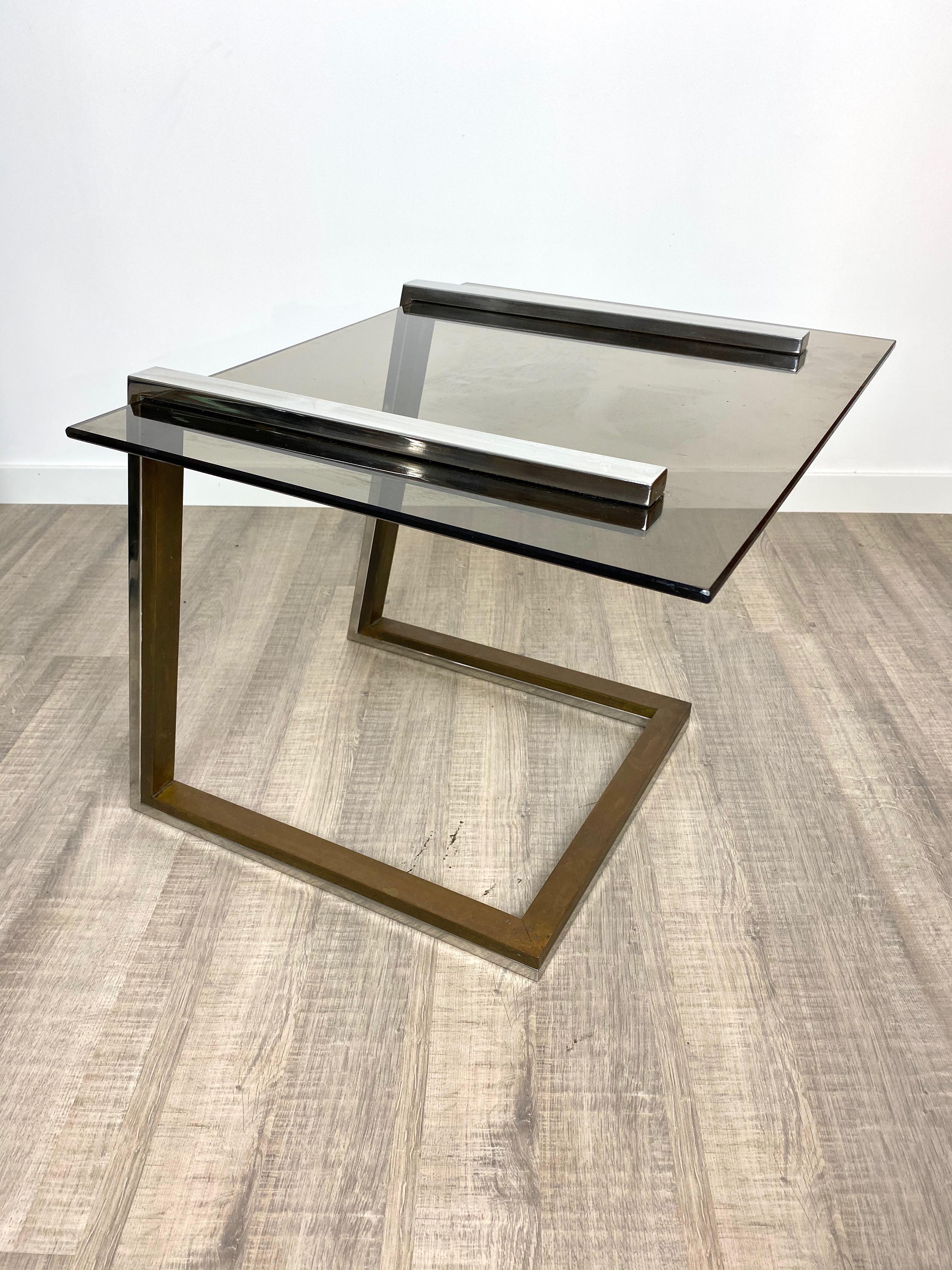 Coffee side table in the style of the Italian designer Romeo Rega in a chrome and brass structure and smoked glass surface. Italy, circa 1970.
