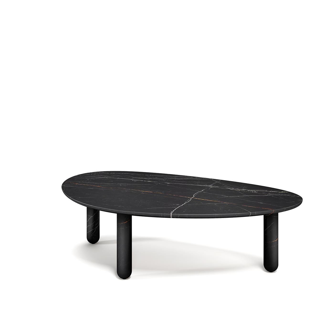Coffee table entirely made in New Saint Laurent marble. The three cylindrical legs made from a solid block are connected to the asymmetrical curved top to create an organic, pebble-like sculpture.