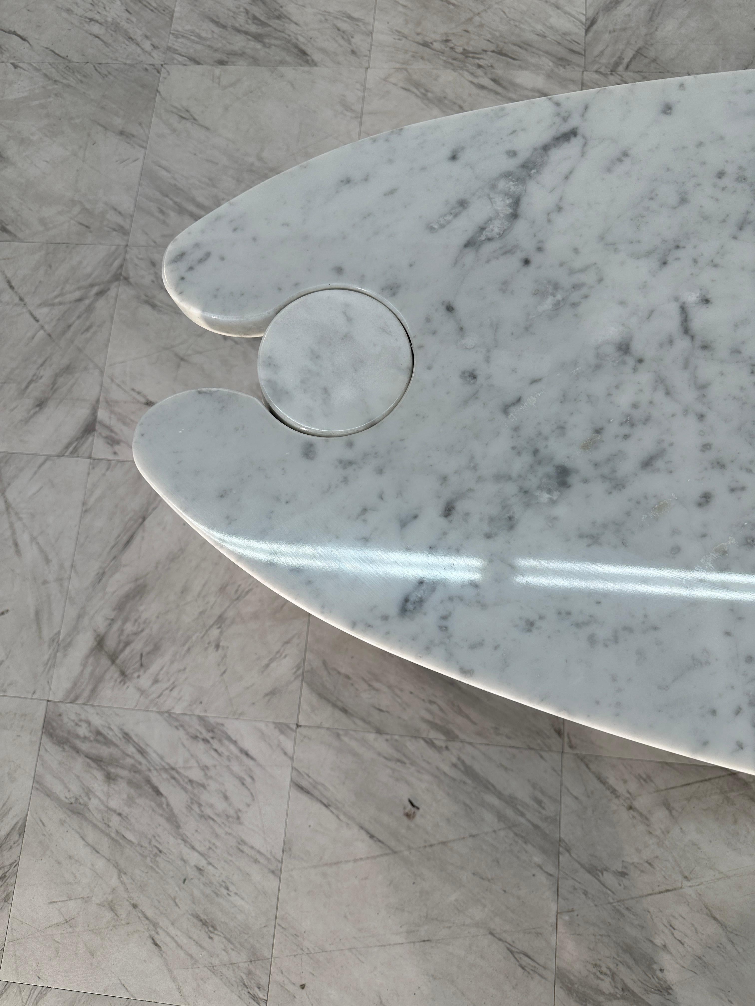 Certainly! The Coffee Table by Angelo Mangiarotti, crafted in the midcentury Italian design of the 1970s, is a striking piece characterized by its oval shape. The table features original Skipper conical-shaped pedestals, adding a unique and stylish