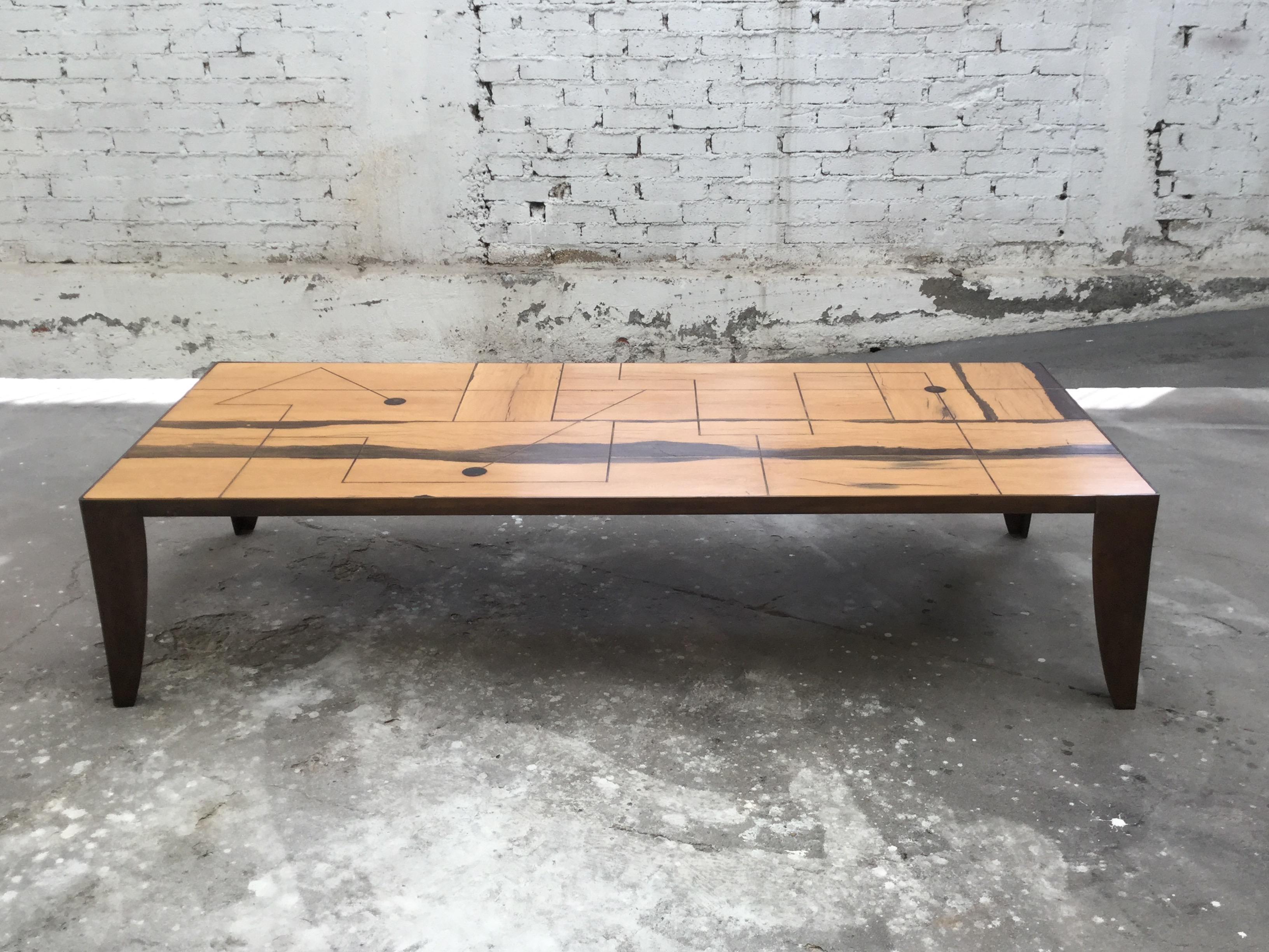 This one-of-a-kind coffee table has been constructed from antique railroad ties of tropical woods, somewhat plentiful a century ago but today a rare find. 
cut and set in bronze legs in the lost wax method, the brass inlay work interplays with the