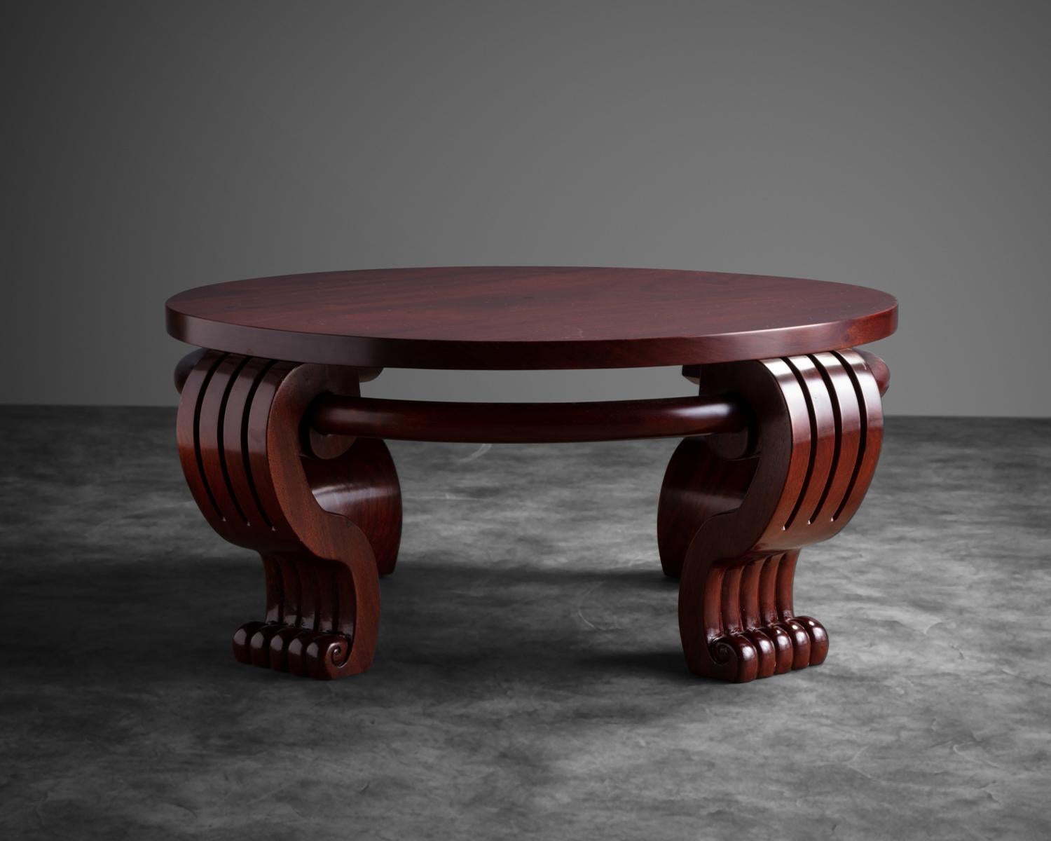 Mahogany veneered coffee table raised on four wide out-scrolled legs, connected by a thick bar which runs parallel to the table edge.
Similar gueridon pictured in Susan Day’s Jean-Charles Moreux p. 199


  