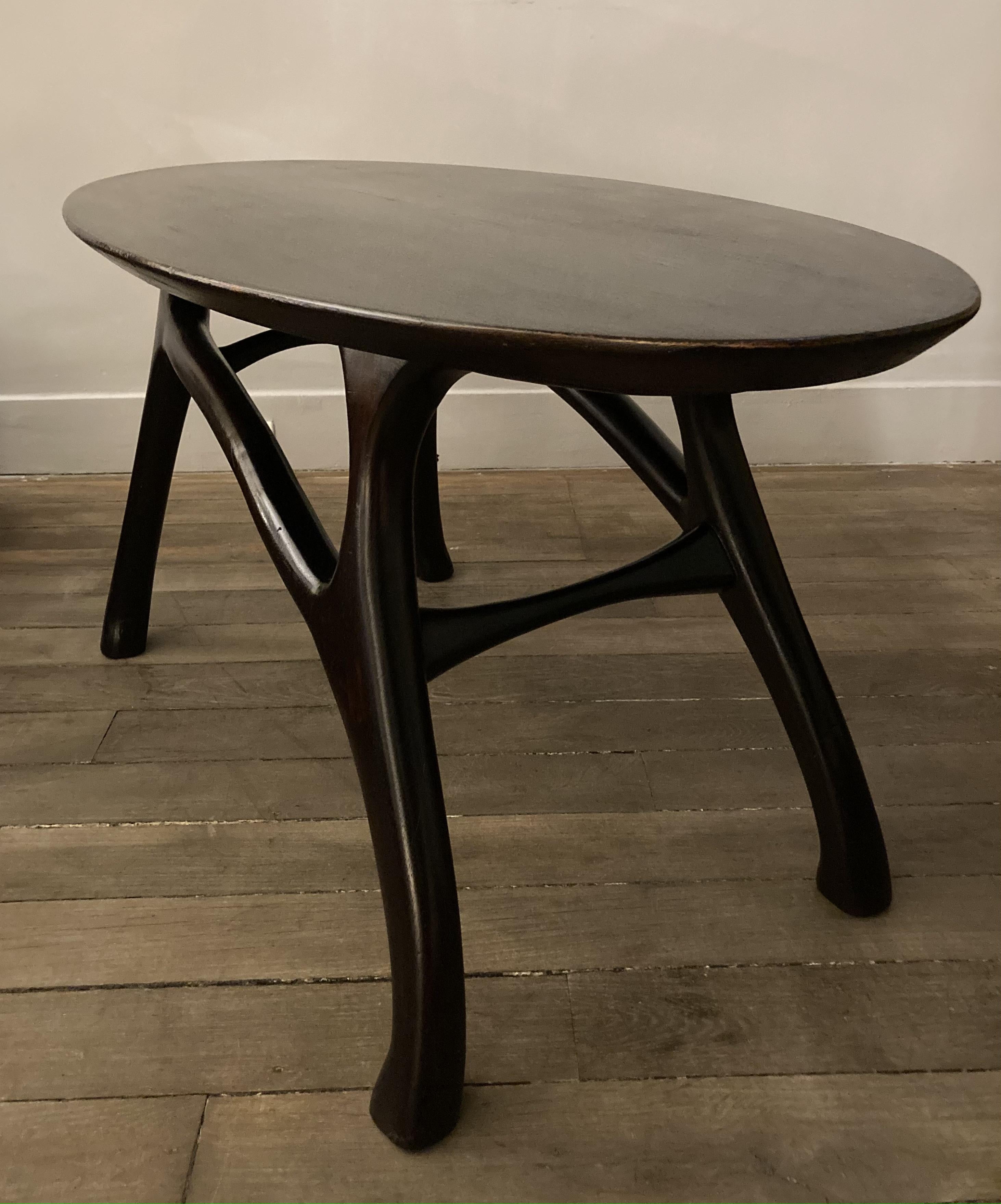 A coffee table, oval top on an organic base. 
Dark stained mahogany 
Attributed to Ico Parisi.
Italy
1950
Dimensions :
Height : 20,86 inch
Width : 44,48 inch
Length : 21,25 inch.