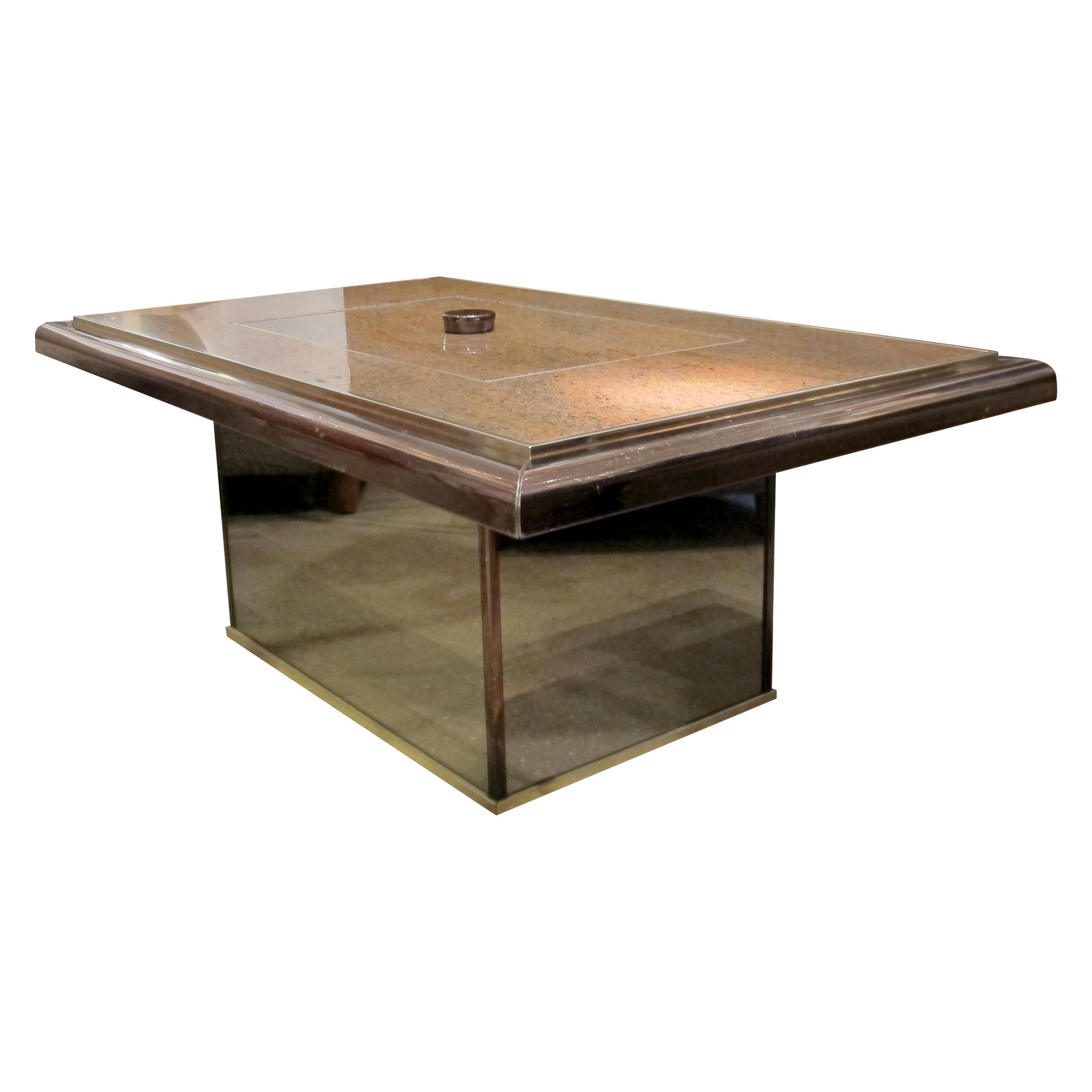 A Belgian table-bar coffee table by Fedam from the 1980s, made of granite, brass, and smoked mirror. The table features a central bar compartment with a mechanised lift that moves up and down with a soft-close mechanism. The combination of materials