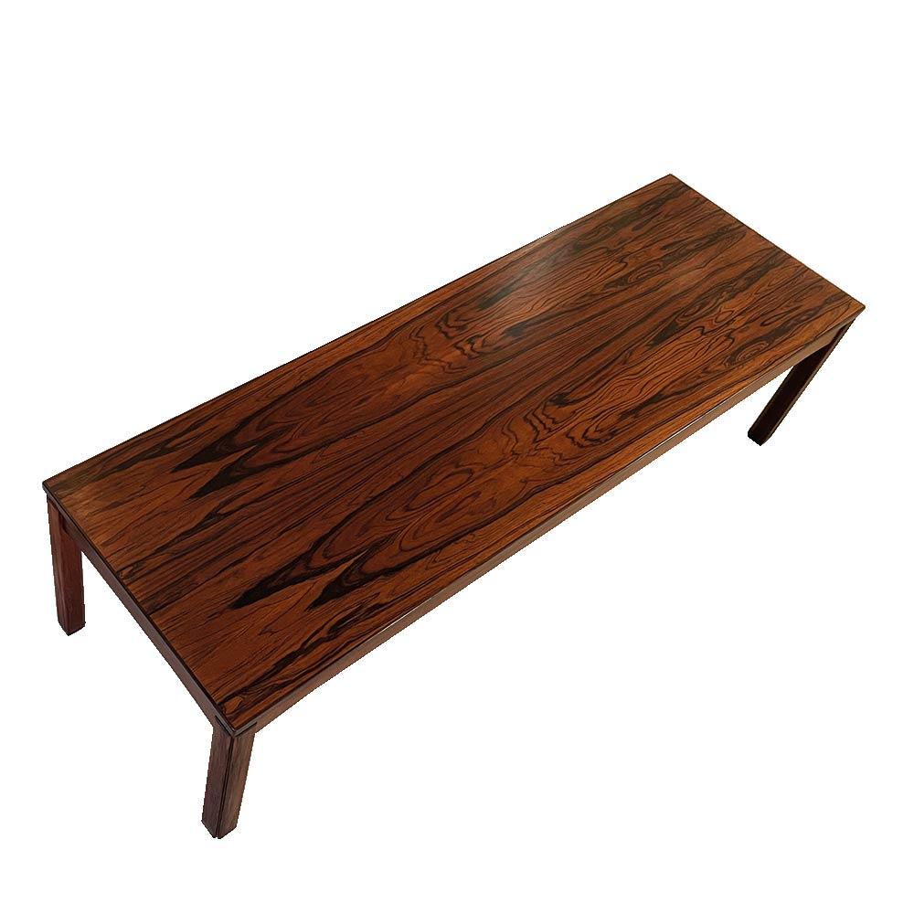 A very beautiful coffee table – bench representative of modernist Scandinavian design. The graphic and clean lines make this table an elegant and timeless choice. Its sleek design and light structure highlight the veining and warmth of rosewood. A