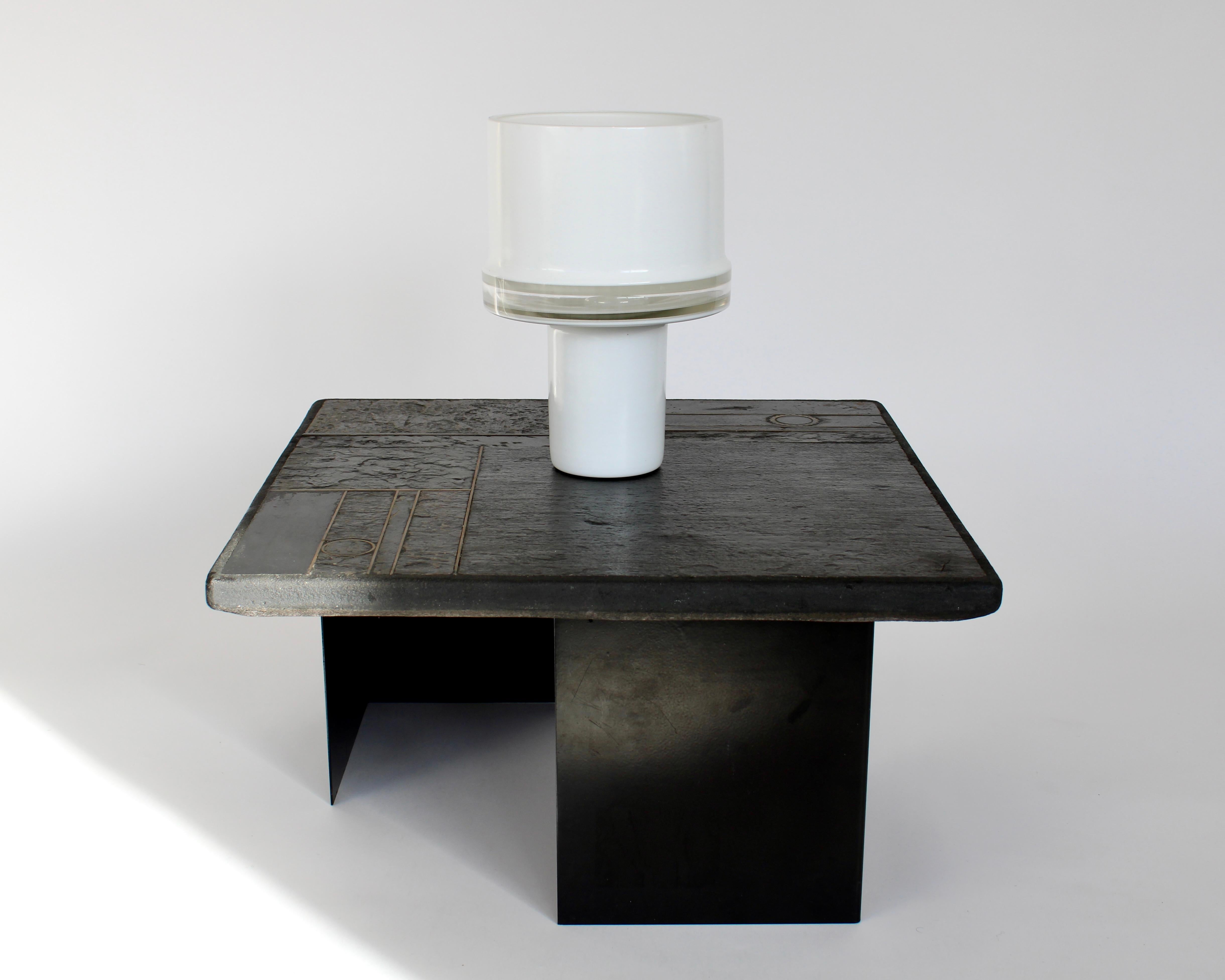 Black Belgian Marble and bronze, brass and agate inclusions side or small coffee table resting on 2 L shaped black powder coated steel bases. Attributed to Paul Kingma. Unsigned. 