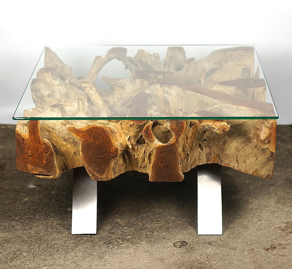 Coffee table, Inhouse production (Designer Cocomaster)

Beautiful organic teak root coffee table with stunning erosion detail, with a tempered glass plate (10mm) on the top and legs made of stainless steel. Oiling the root gives its special unique