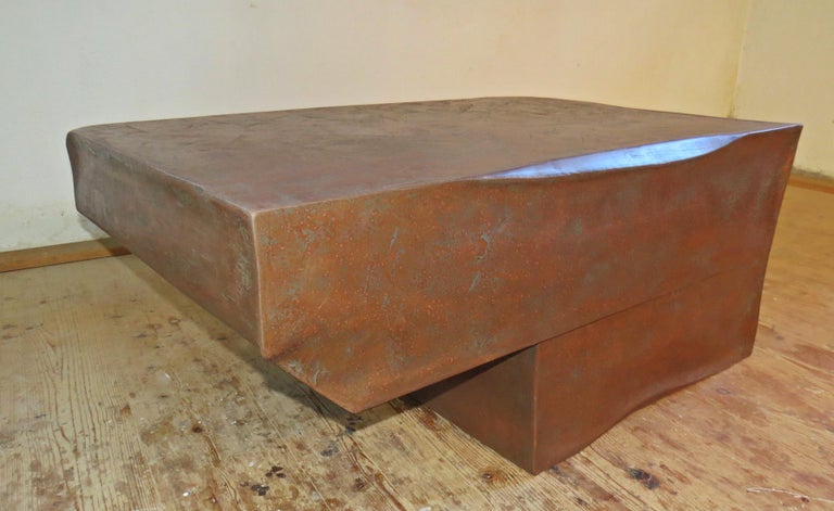 Single piece as a coffee table
handmade in Germany by the designer Eckehard Weimann.
The organic form is reminiscent of an anvil.
Made of plywood, which is sculpted and then coated with bronze.


   