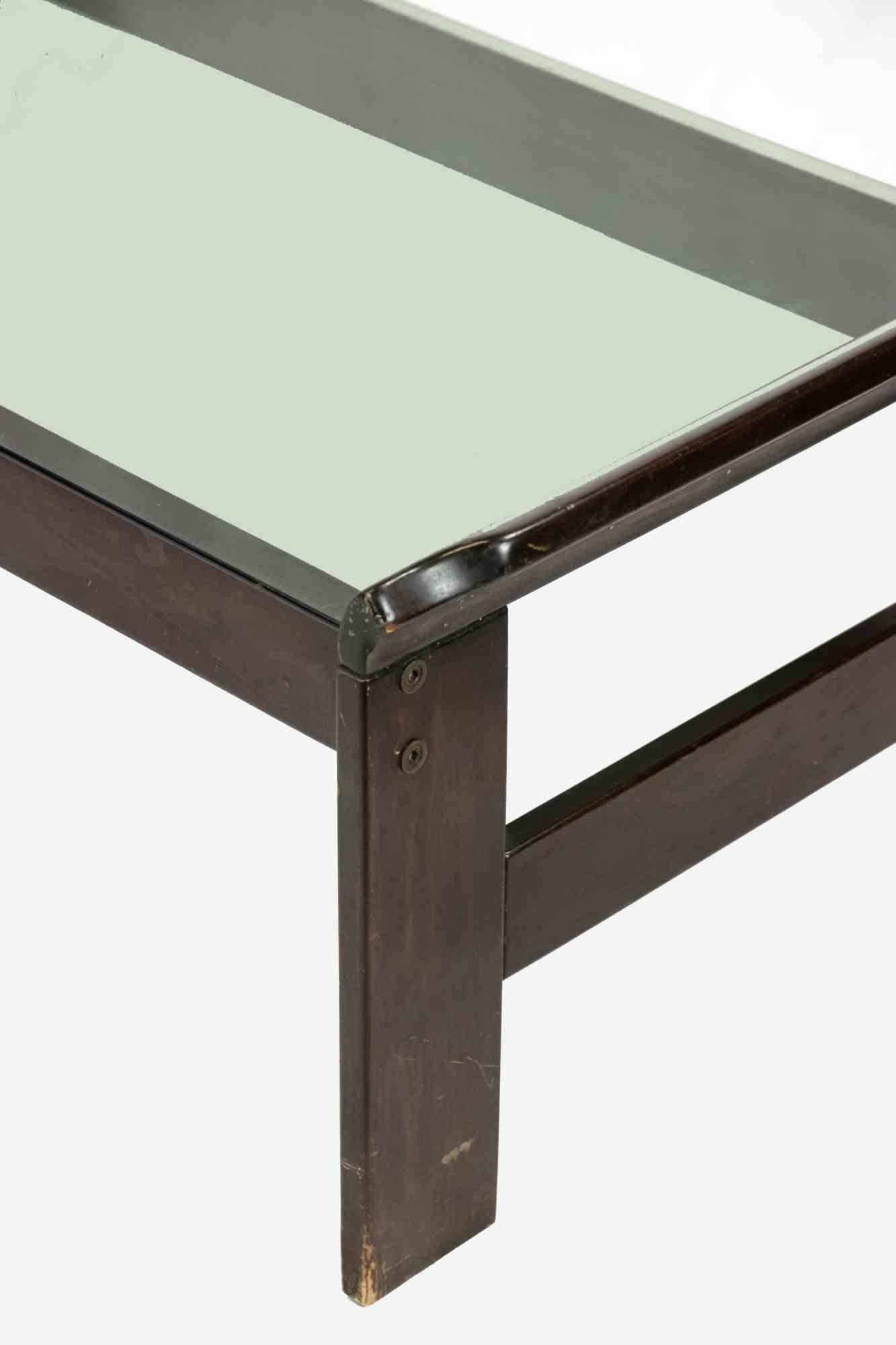 Coffe table is an original design furniture item realized by Afra and Tobia Scarpa in the 1970s

A vintage coffee table realized in mahogany wood ant glass top.

Mint conditions except for some scratches and dents on the wood.