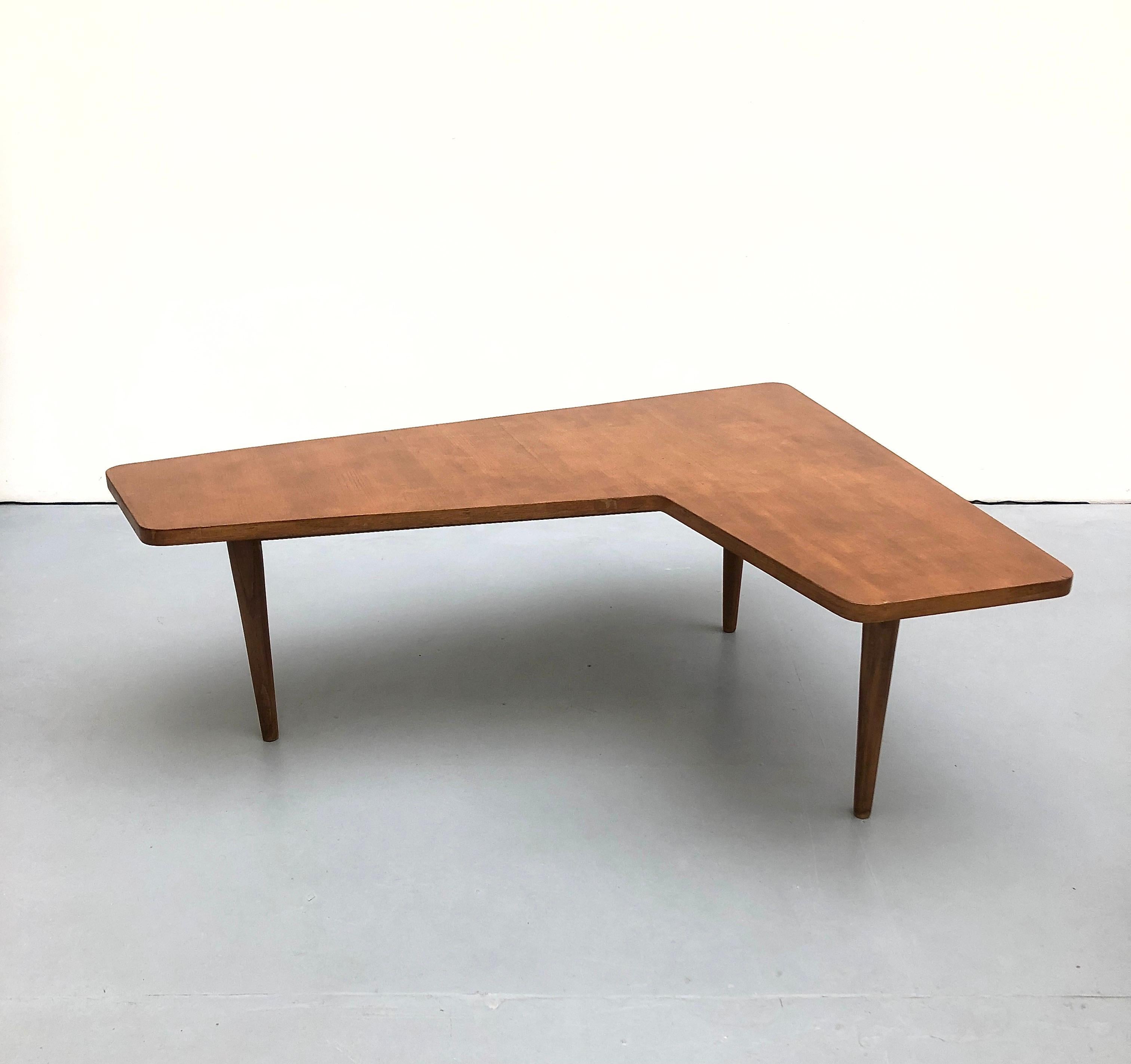 Coffee table by Alain Richard, Charron Groupe 4, 1954.

Alain Richard did not design the cut-out of this table from scratch: an armchair can easily be fitted into it and its occupant then has a very large surface to place books, papers, ashtrays,