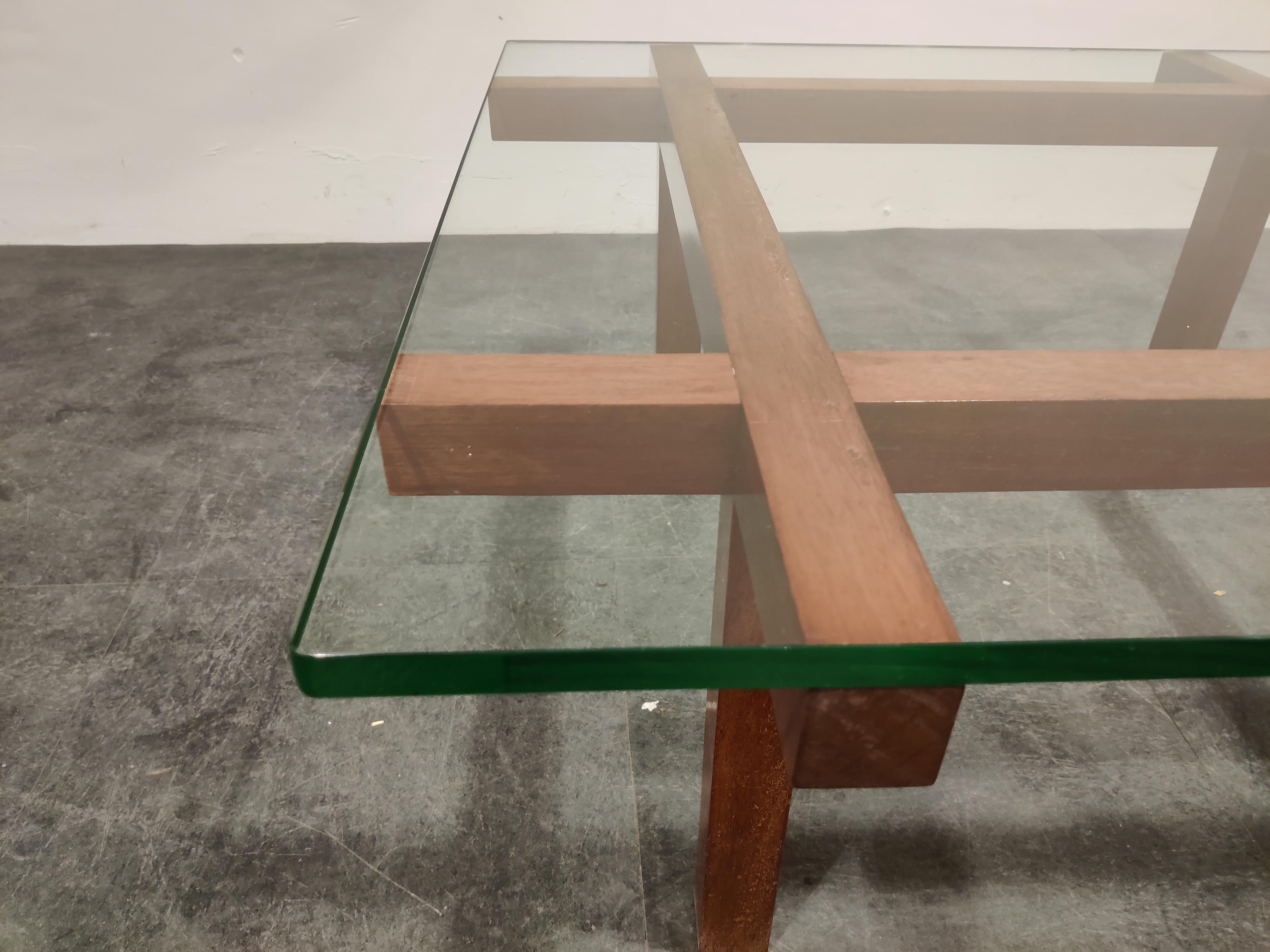 Minimalist coffee table by the Belgian designer Alfred Hendrickx for Belfom.

Made from a geometric teak base and a thick glass top.

One of our favorite (belgian) designers of the midcentury era.

Good condition.

1960s -
