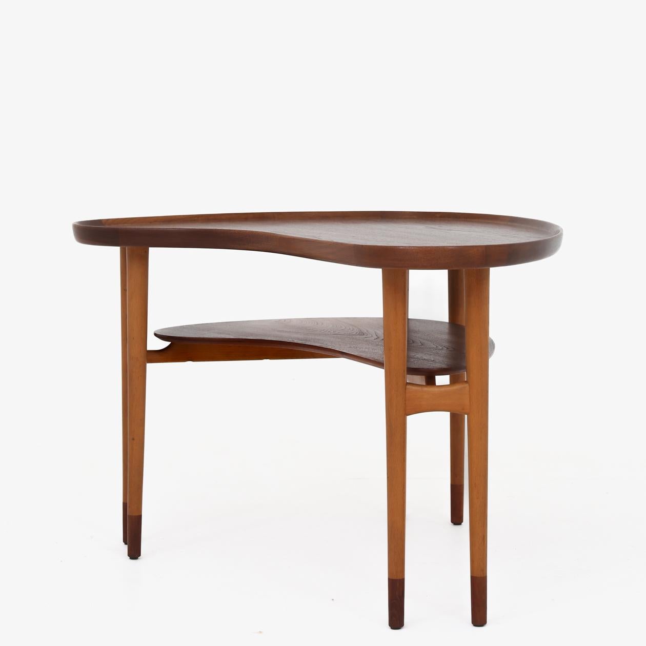 Coffee table with a fluted edge. Top and shoes in teak and frame in patinated beech. Arne Vodder / Bovirke.
