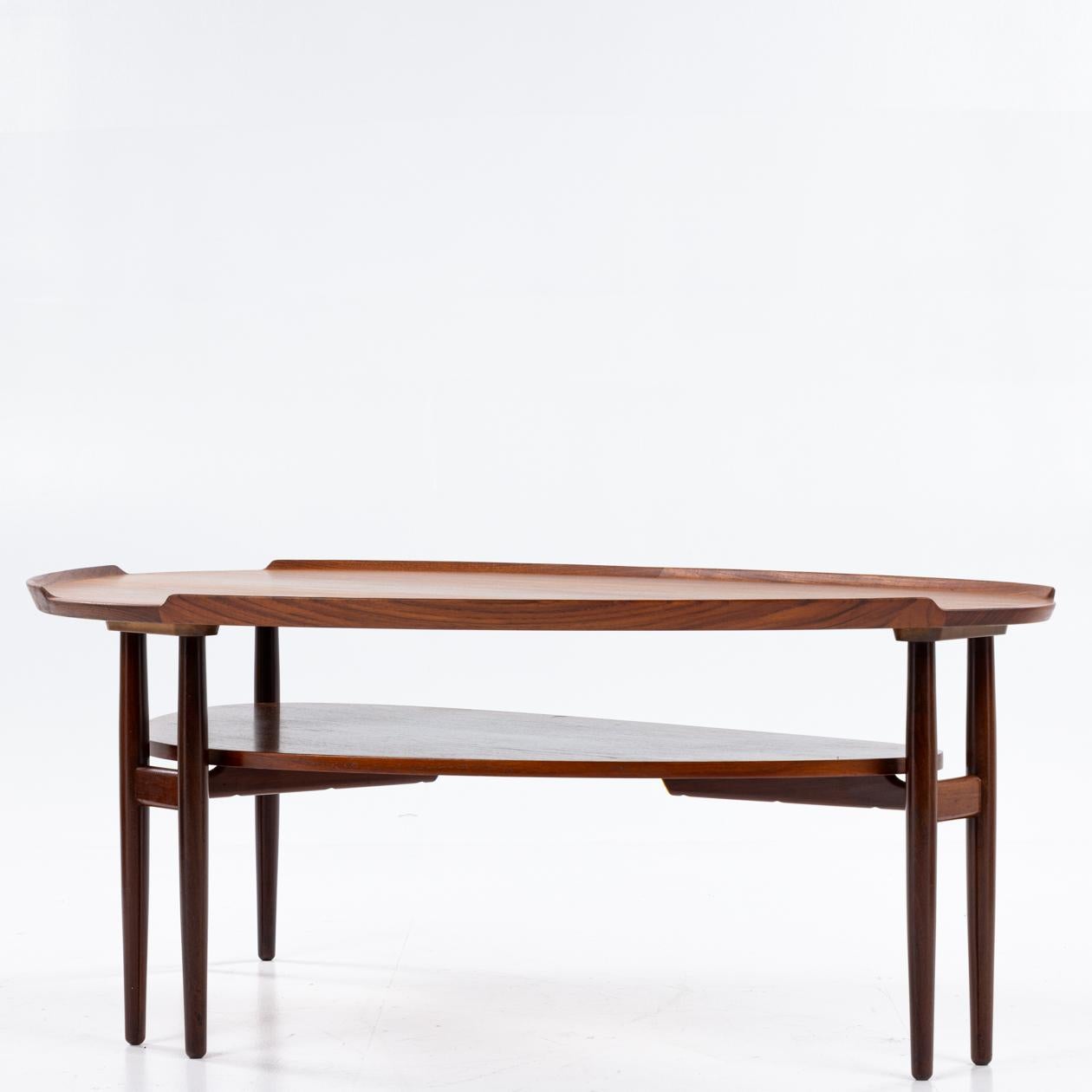 Coffee table with six legs in walnut. By Arne Vodder / Sibast furniture.