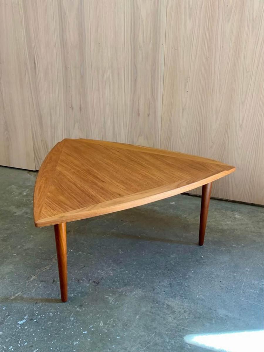 A true Danish modern gem, this rare 1960s coffee table by Arne Wahl Iversen brings sculptural sophistication to any space. Crafted in richly grained teak, the unique triangular top with softly curved edges showcases Iversen’s flair for organic form